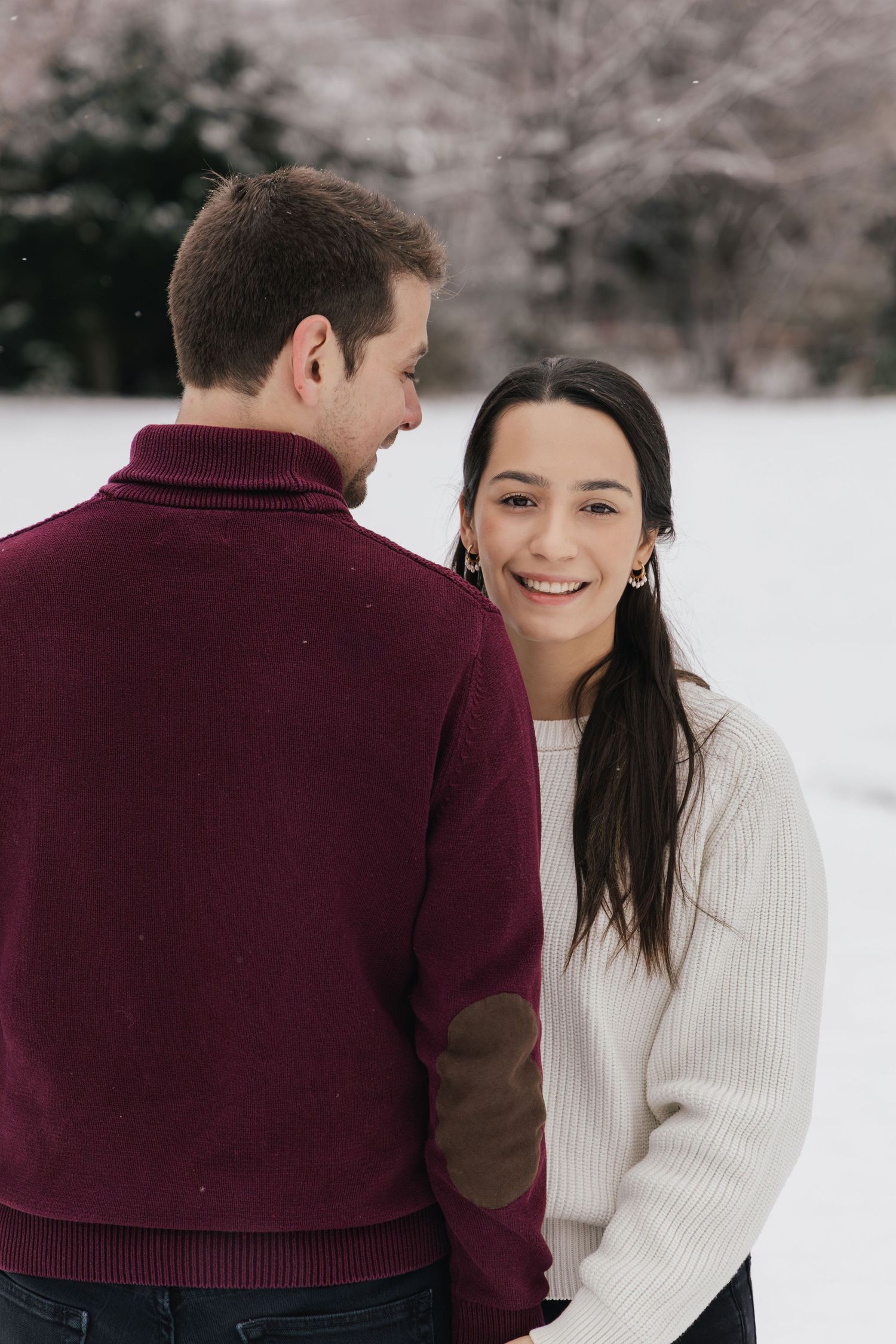 Romantic couple in the snow during a winter couples photoshoot in Switzerland.