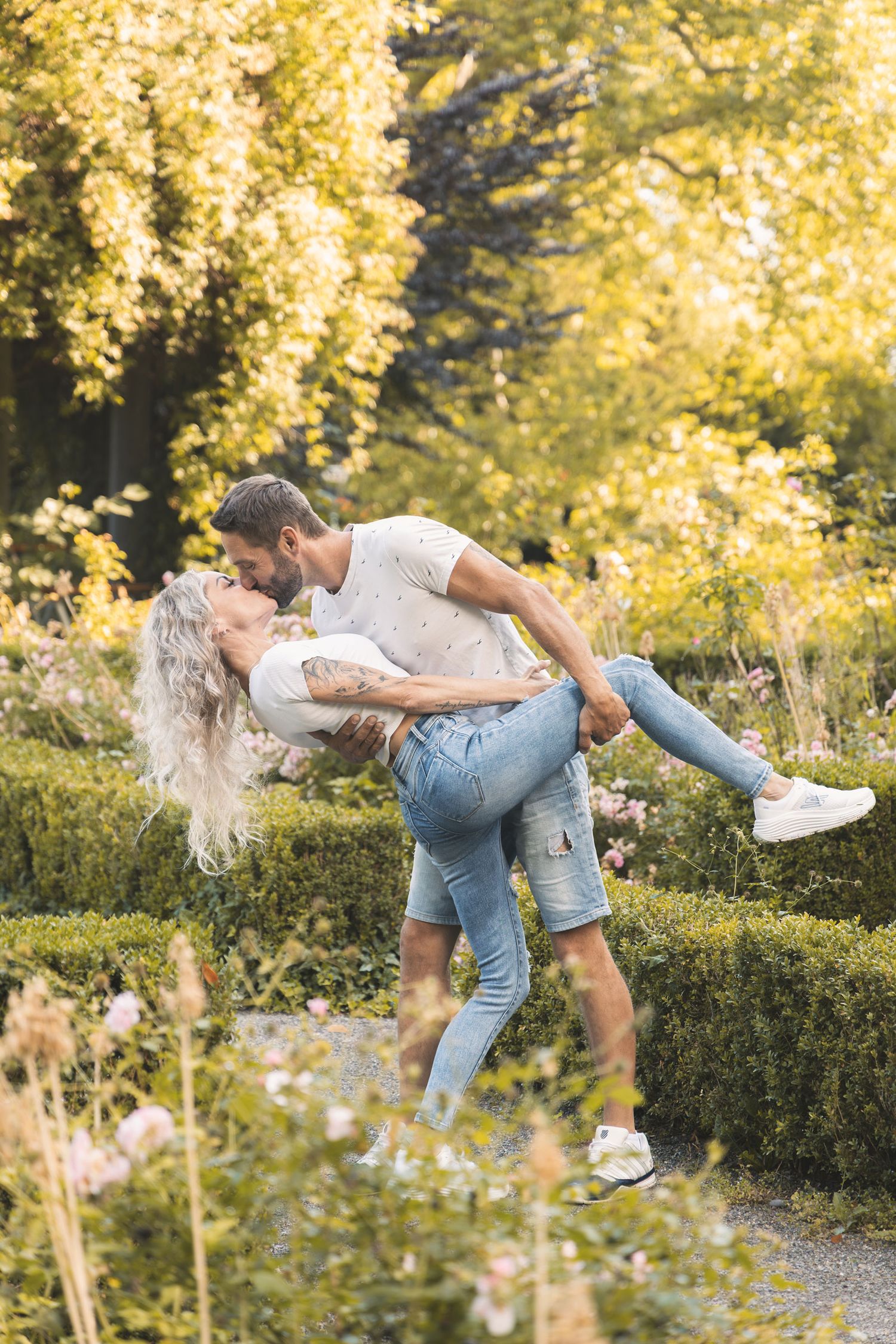 Couple dancing together during a joyful outdoor couples photoshoot in Switzerland.
