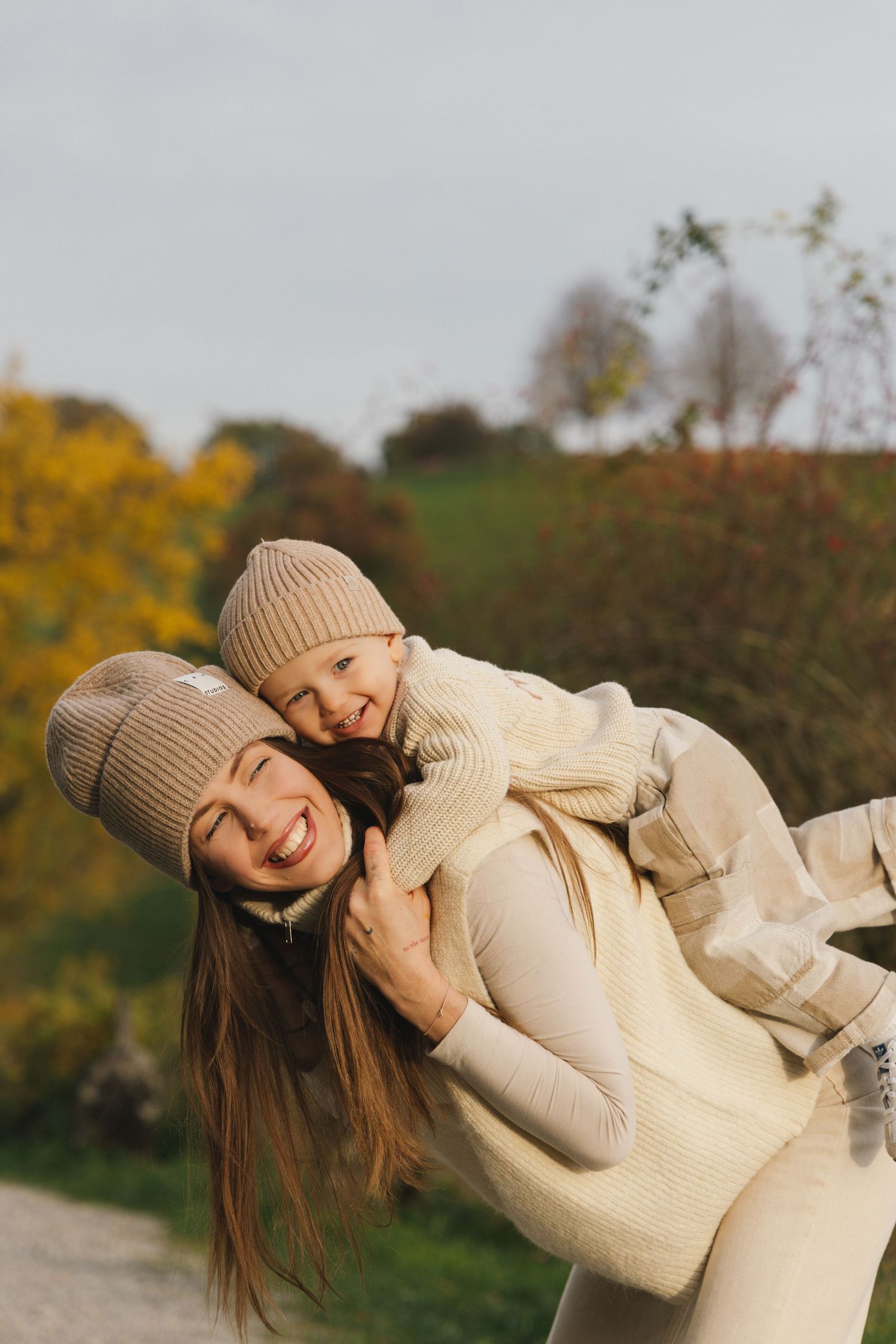 Mother and son laughing together during autumn family photoshoot in Switzerland.