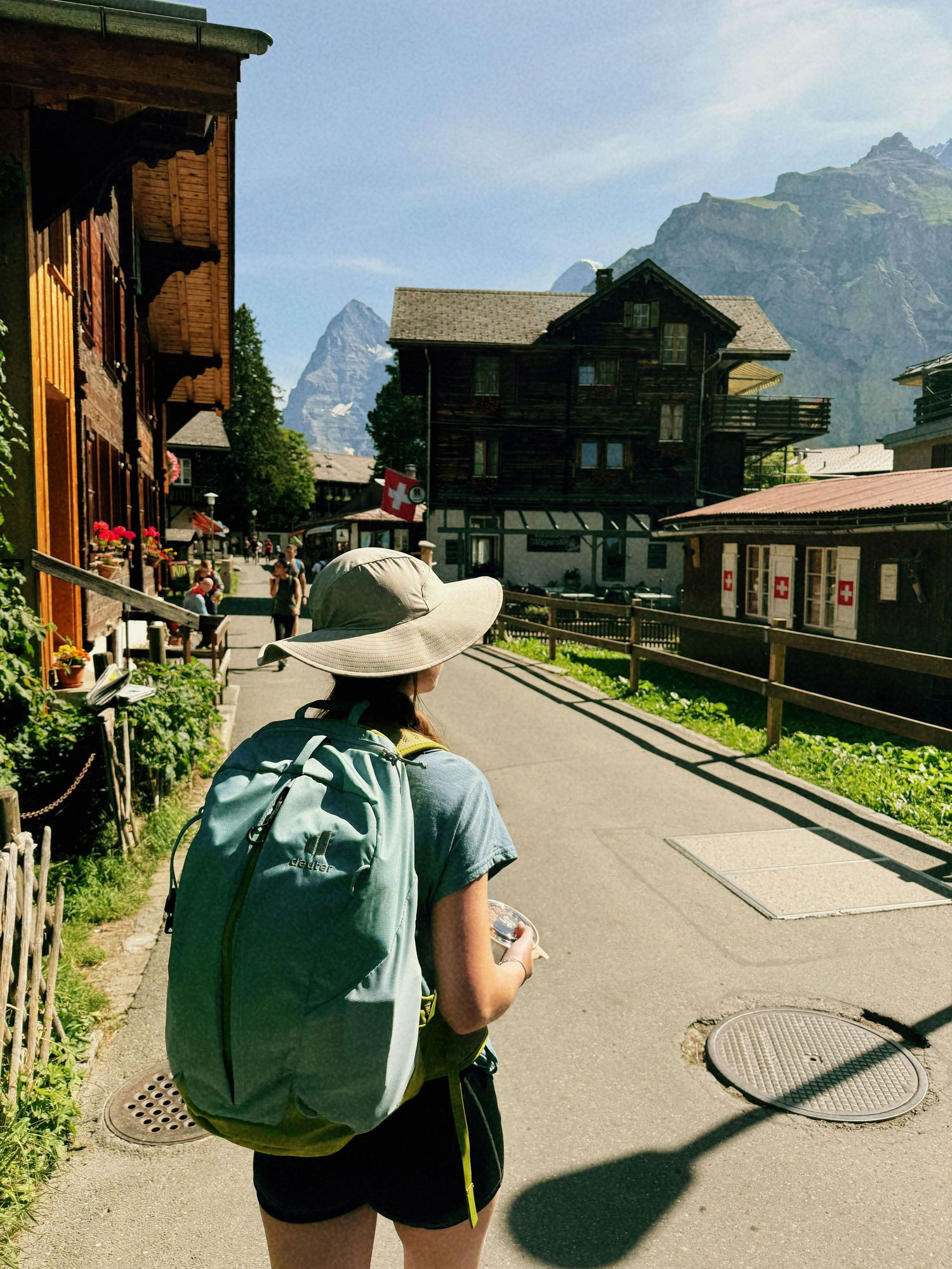 Lifestyle portrait of a photographer walking through a Swiss village in Switzerland.