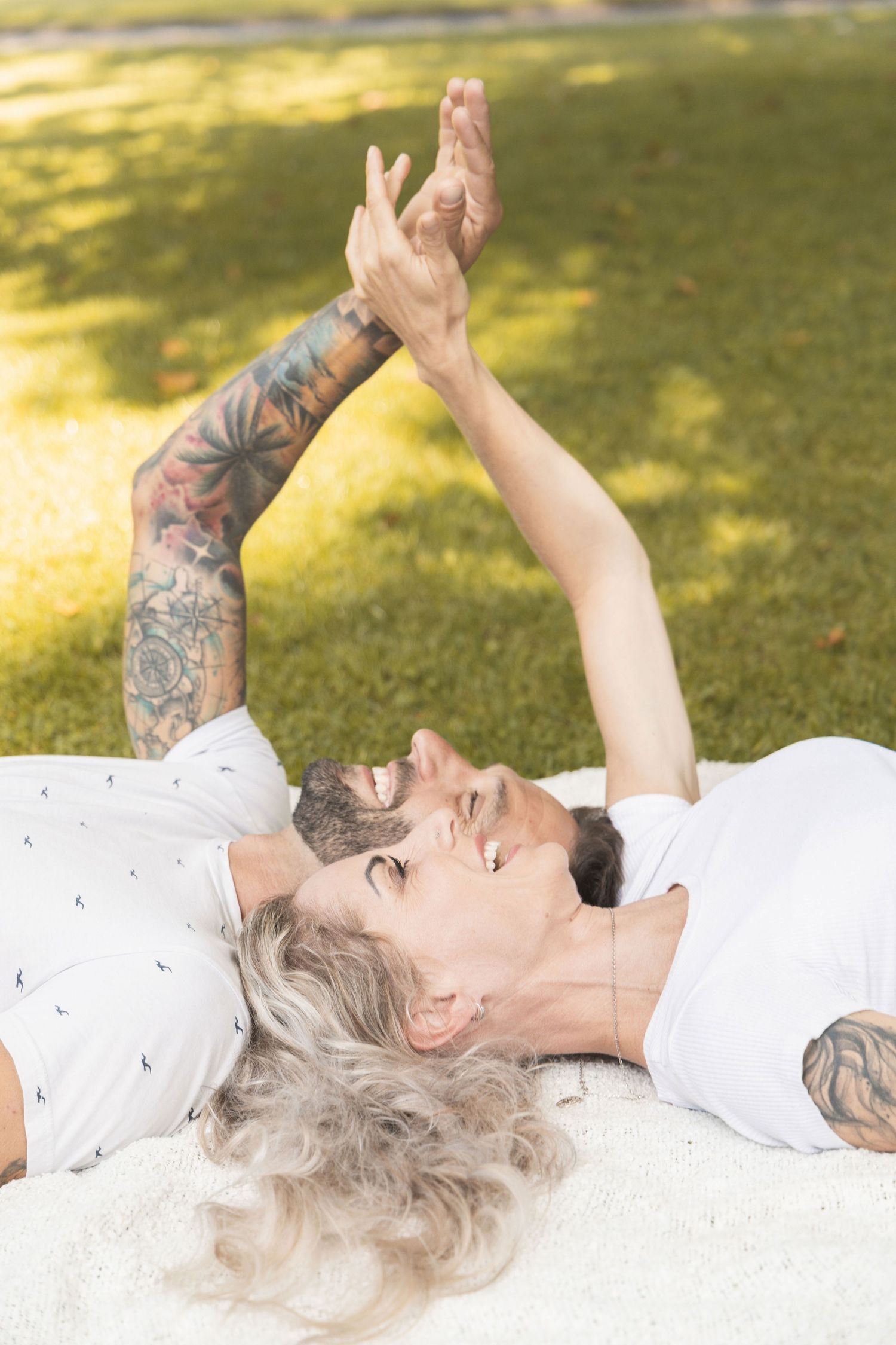 Couple lying on a blanket during a relaxed lifestyle photoshoot in the park,