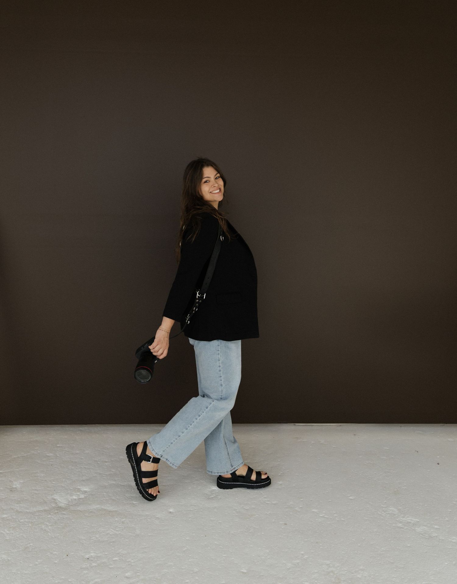 Fashion photo series showing casual outfit with black jacket and jeans against dark background.