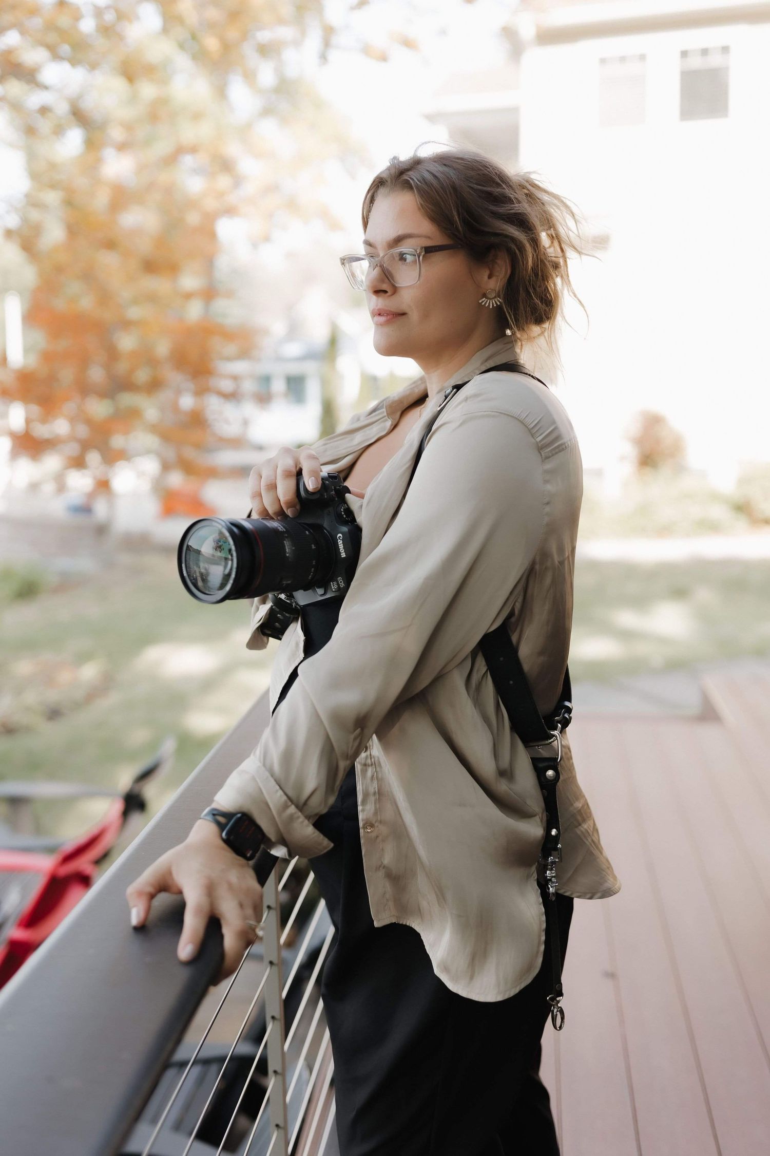 A photographer in a beige blazer and glasses takes photos from different dynamic angles in this action sequence.