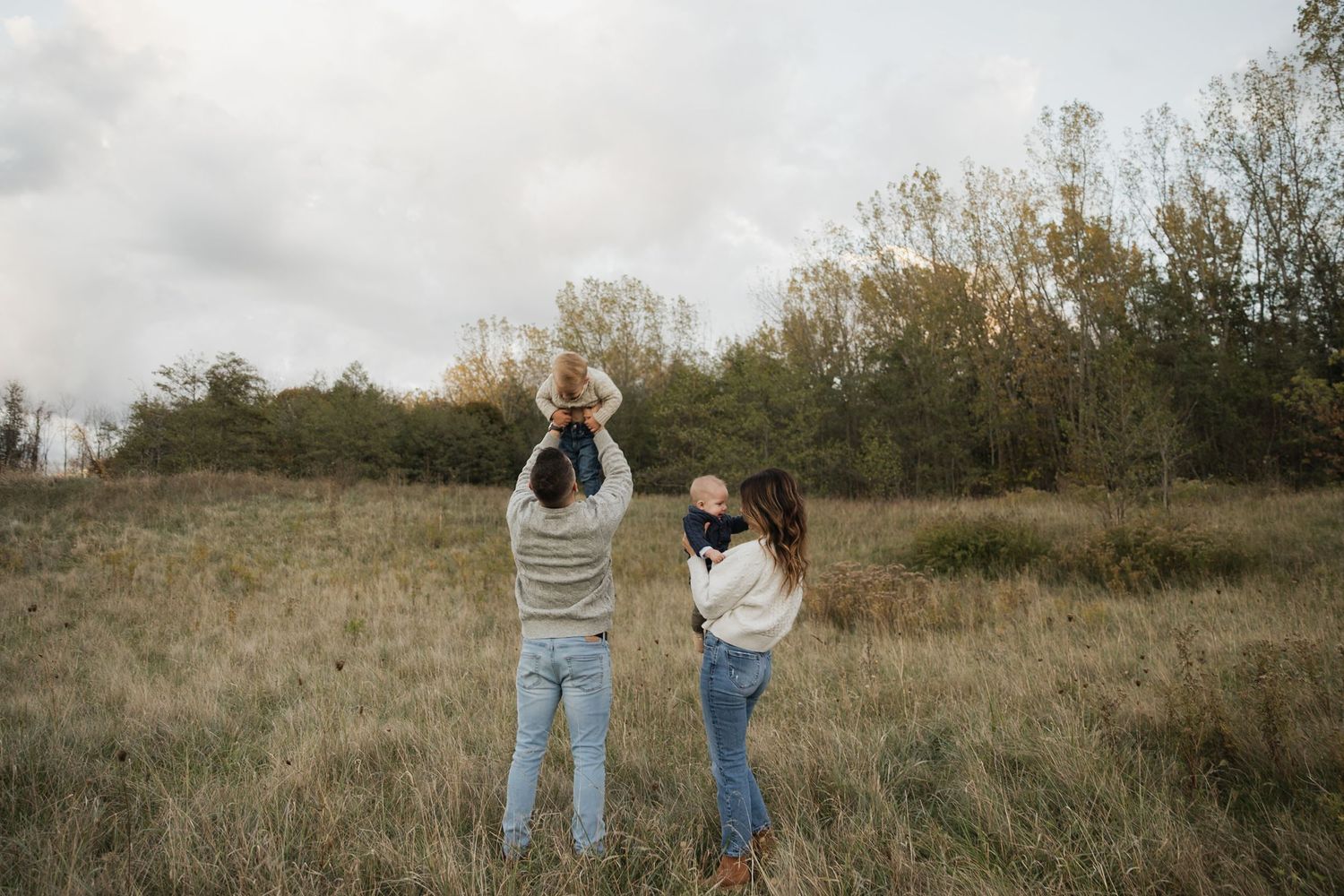 A series of outdoor photos showing two people in casual clothing walking and posing together in a rustic field setting.