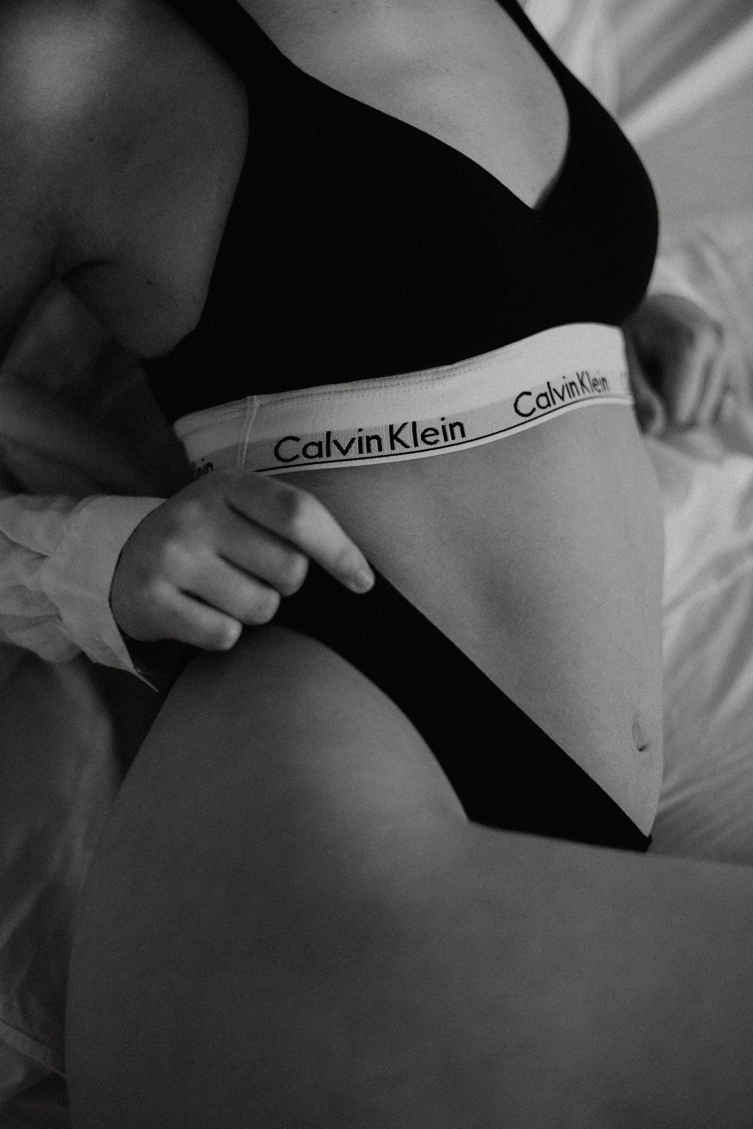 Close-up fashion detail shots of Calvin Klein branded underwear in monochrome.