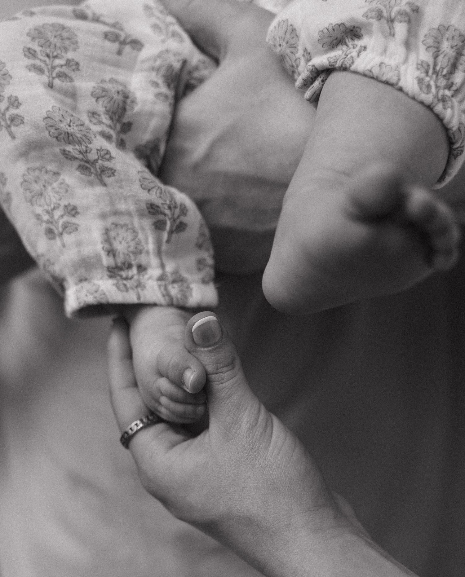 A series of black and white close-up photographs showing gentle hand gestures against a soft background.