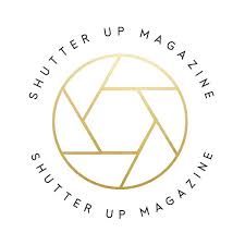 Shutter Up Magazine gold circular logo featuring camera aperture design.