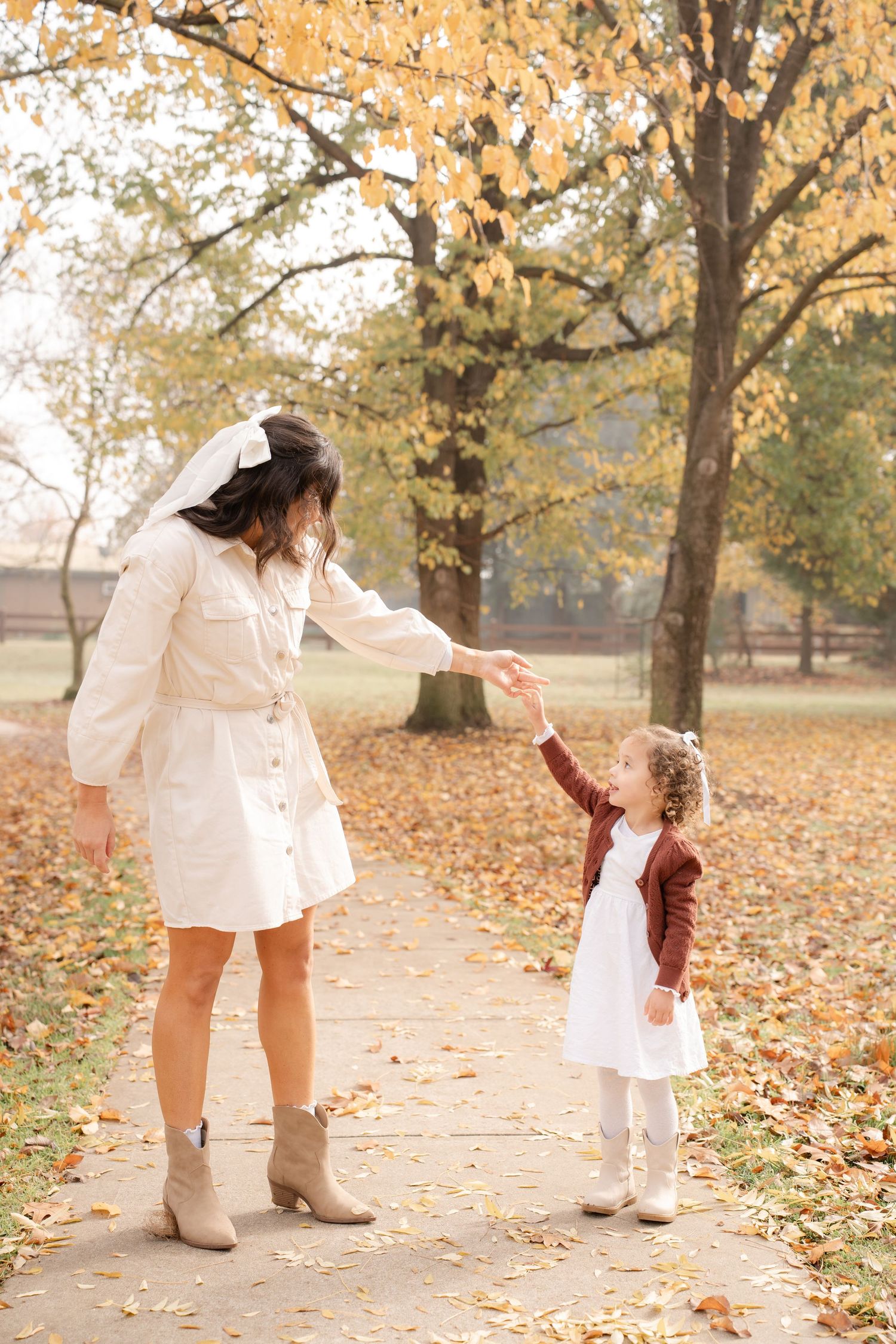 Mum spinning toddler around like a ballerina on a park path in Barooga