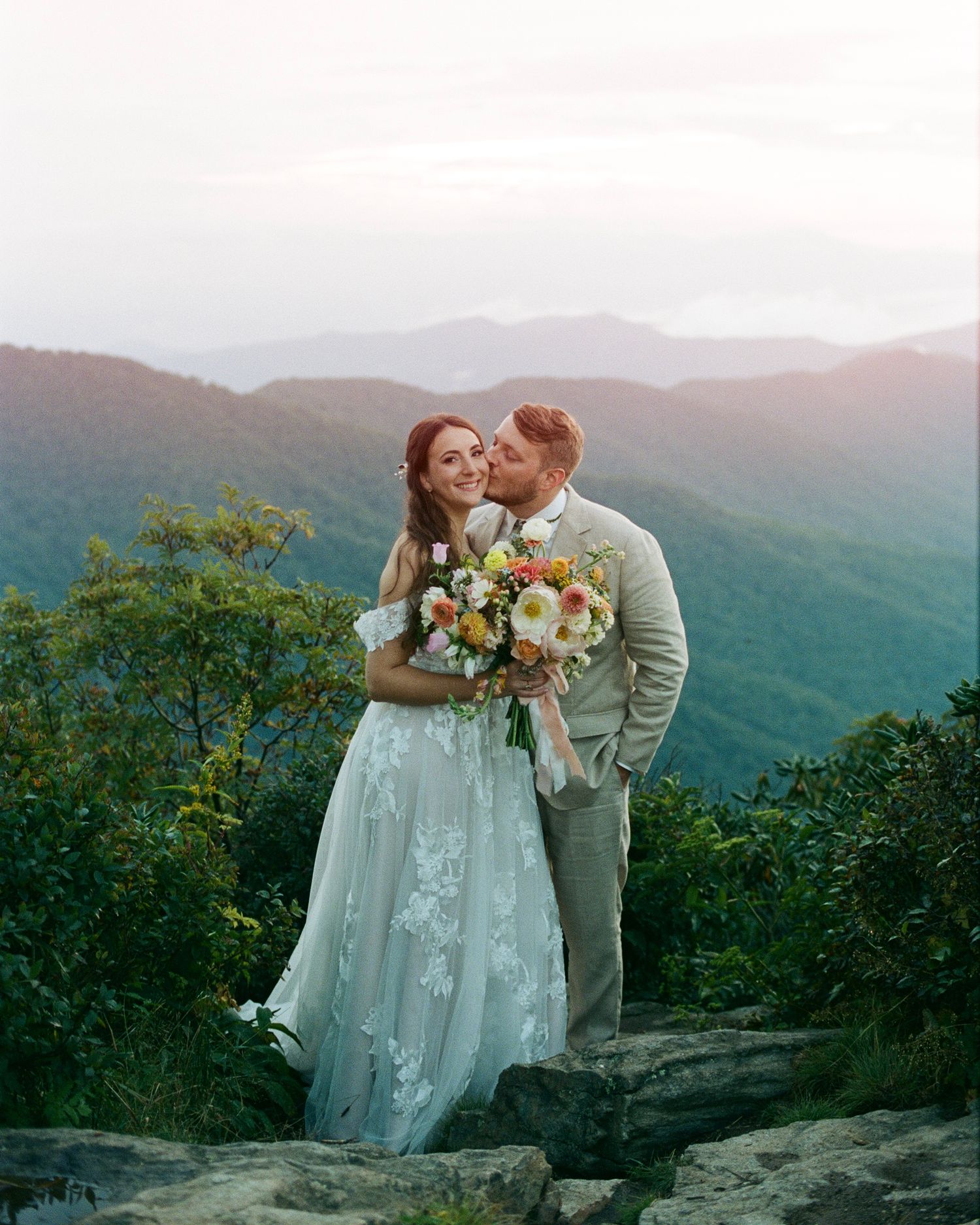 candid, 35mm film image of couple embracing during a craggy gardens asheville elopement