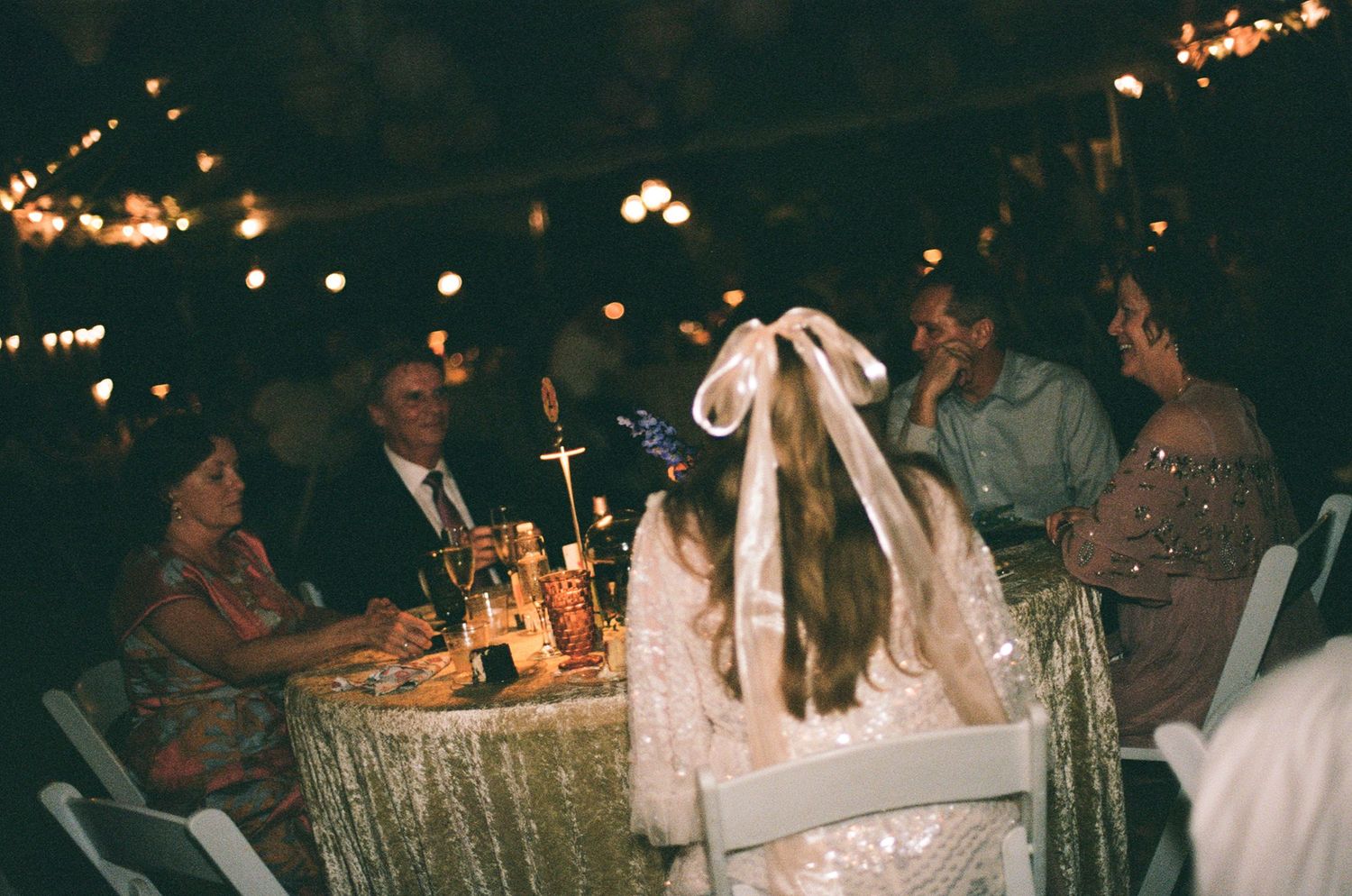 35mm image of Wedding reception guests seated at candlelit table in richmond virginia