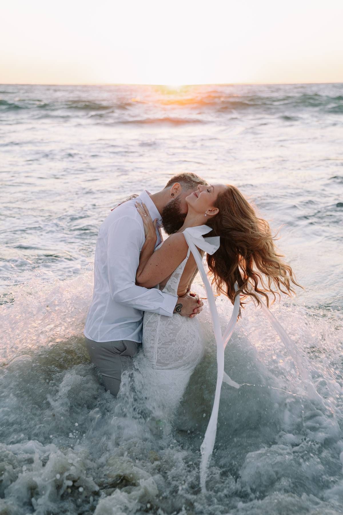 Beach engagement shoot in Perth capturing candid romantic moments, golden hour light, natural connection and documentary style photography