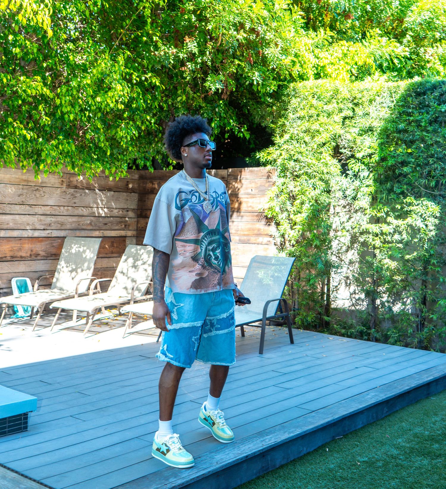 Vibrant outdoor lifestyle fashion portrait of a man on a sunlit deck, captured by Shane Anthony Photography.
