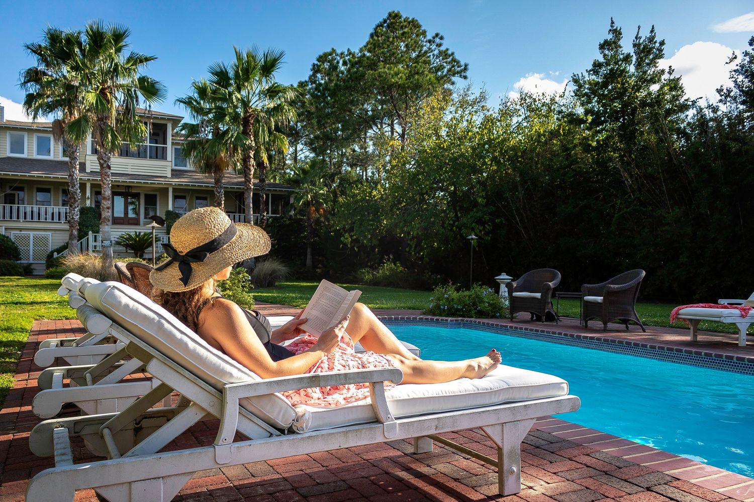 Woman relaxing by the pool at a Tybee Island vacation rental
