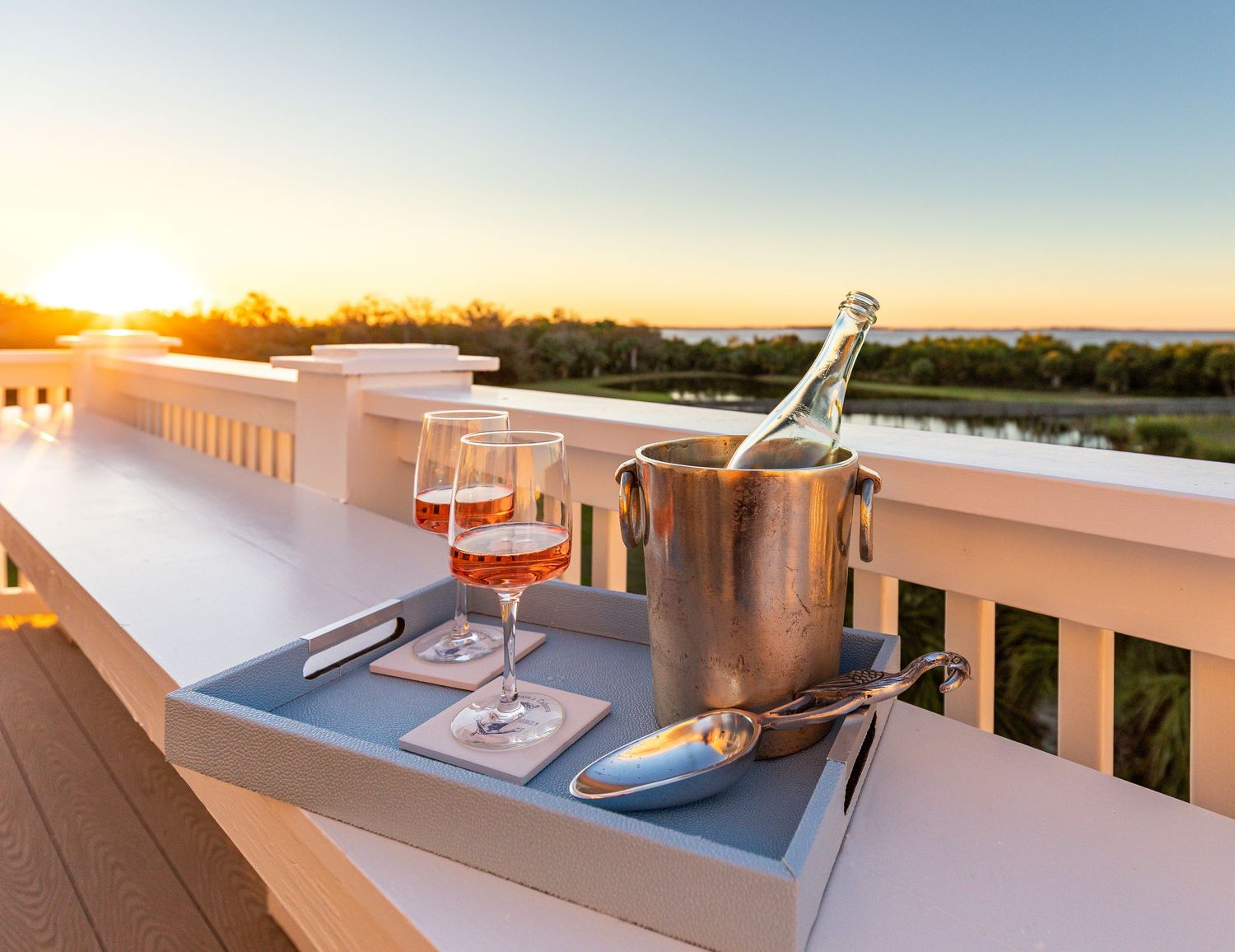 Cocktail tray with copper Moscow Mule mugs and a cocktail shaker on a deck overlooking the marsh at a Tybee Island vacation rental