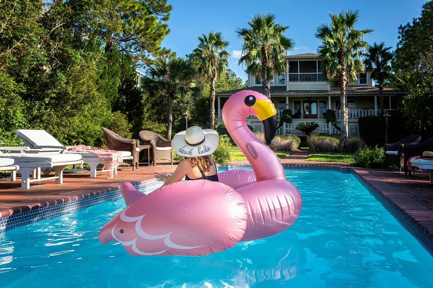 Woman relaxing on a pool float at a Tybee Island vacation rental