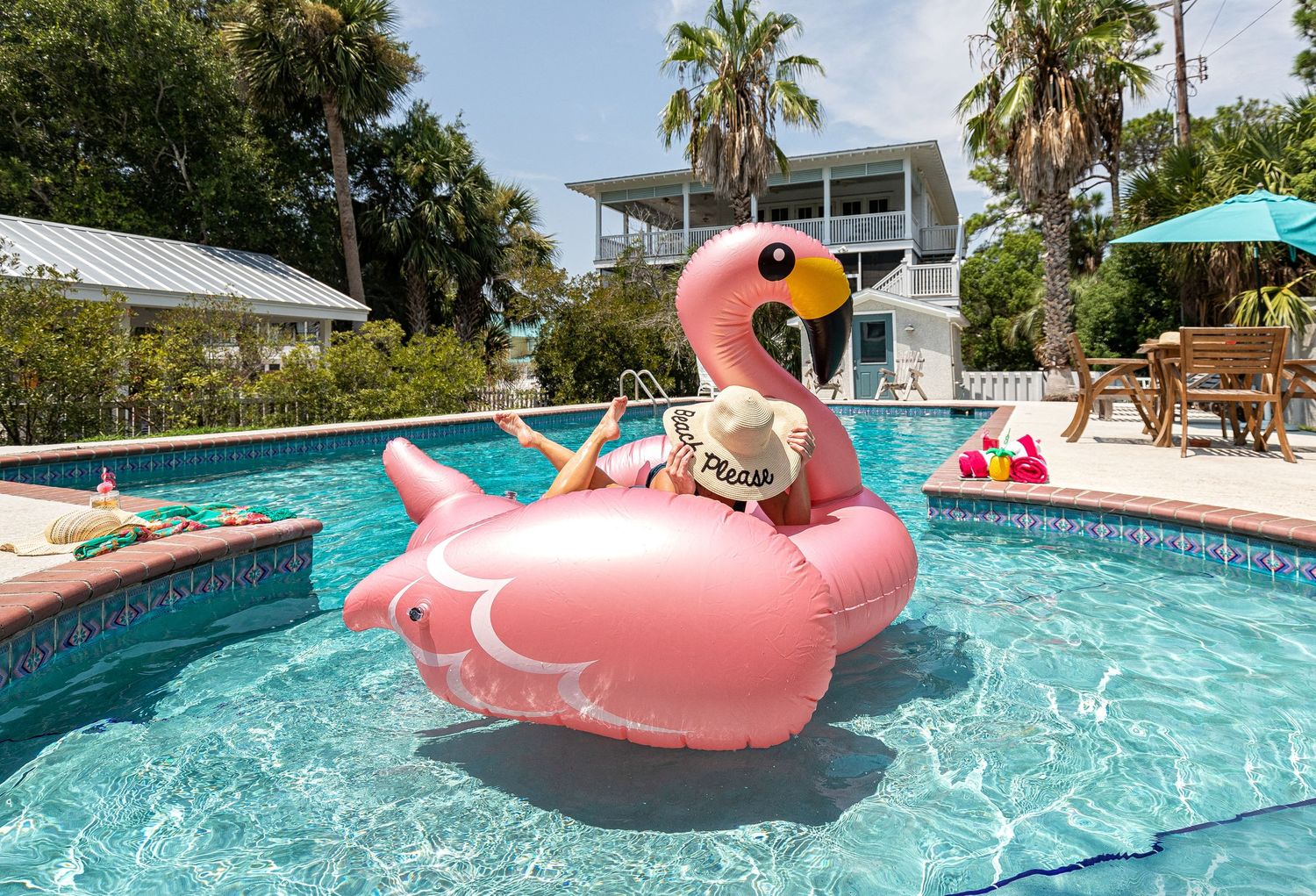 Woman relaxing on a pool float at a Tybee Island vacation rental