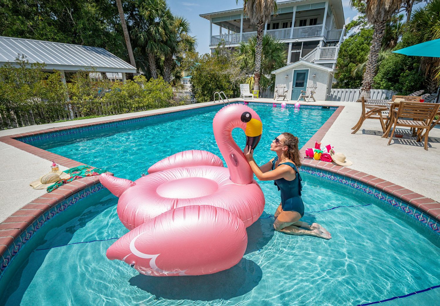 Woman relaxing in a pool with a pool float at a Tybee Island vacation rental