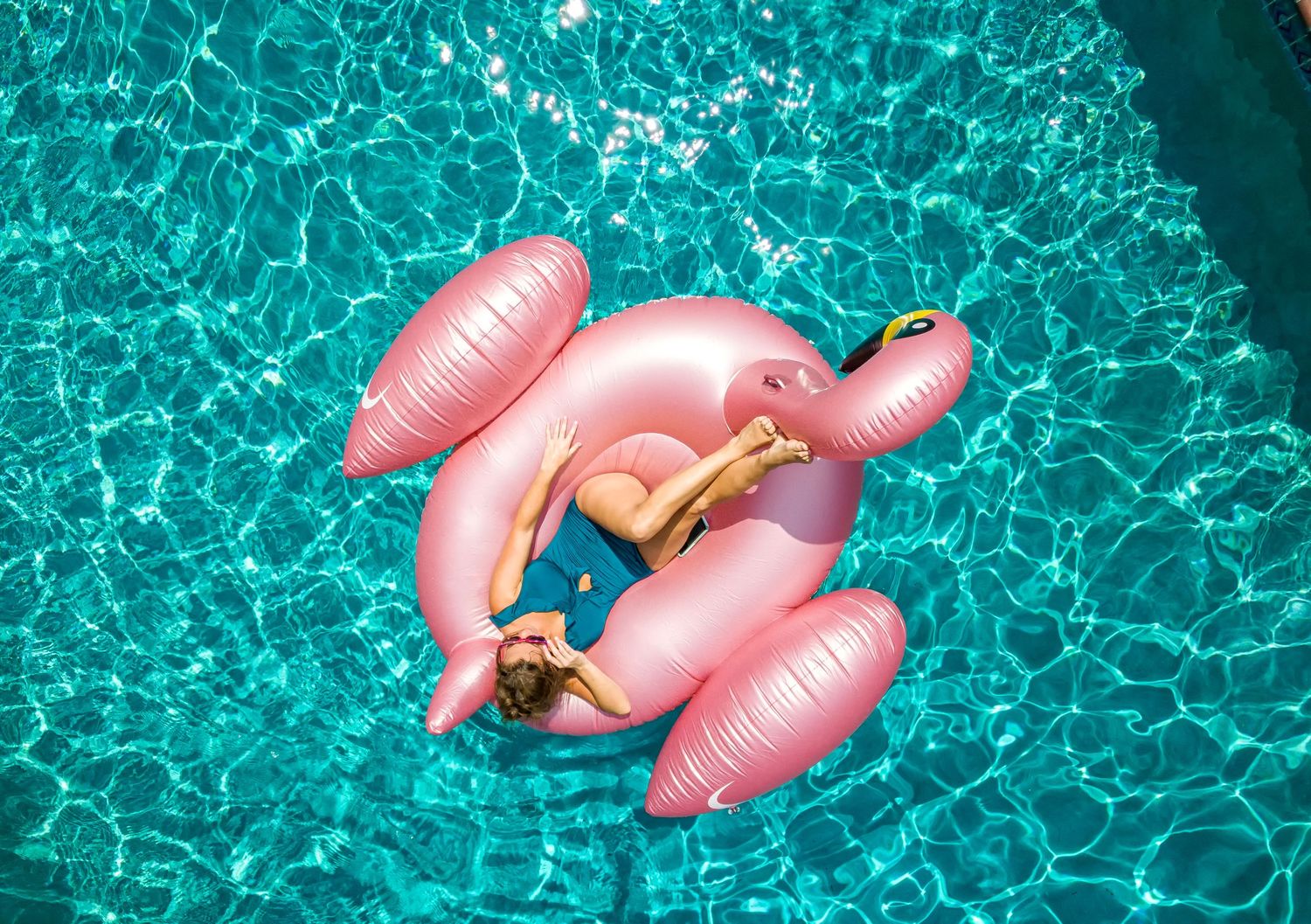 Woman relaxing on a pool float at a Tybee Island vacation rental