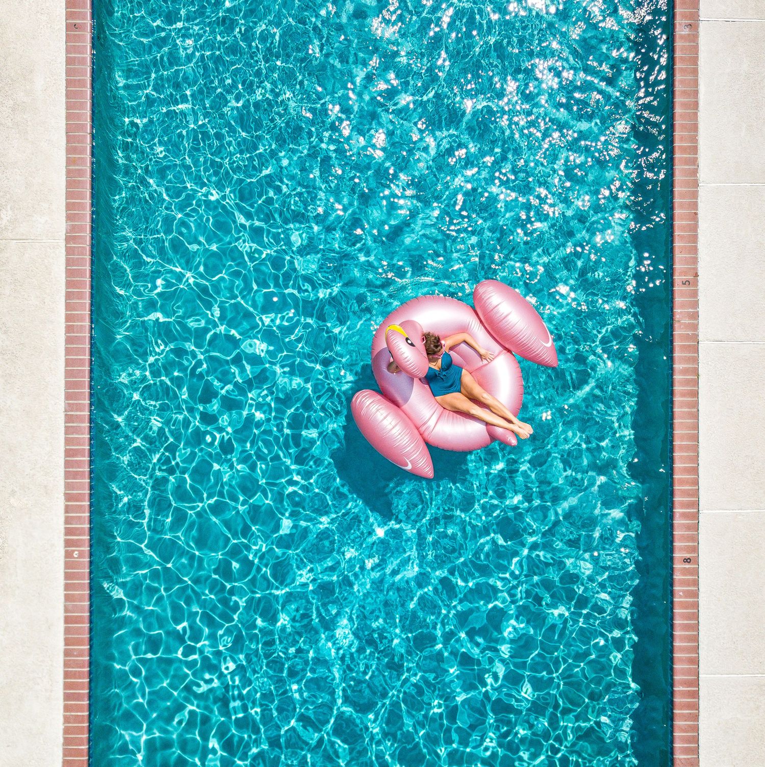 Woman relaxing on a pool float at a Tybee Island vacation rental