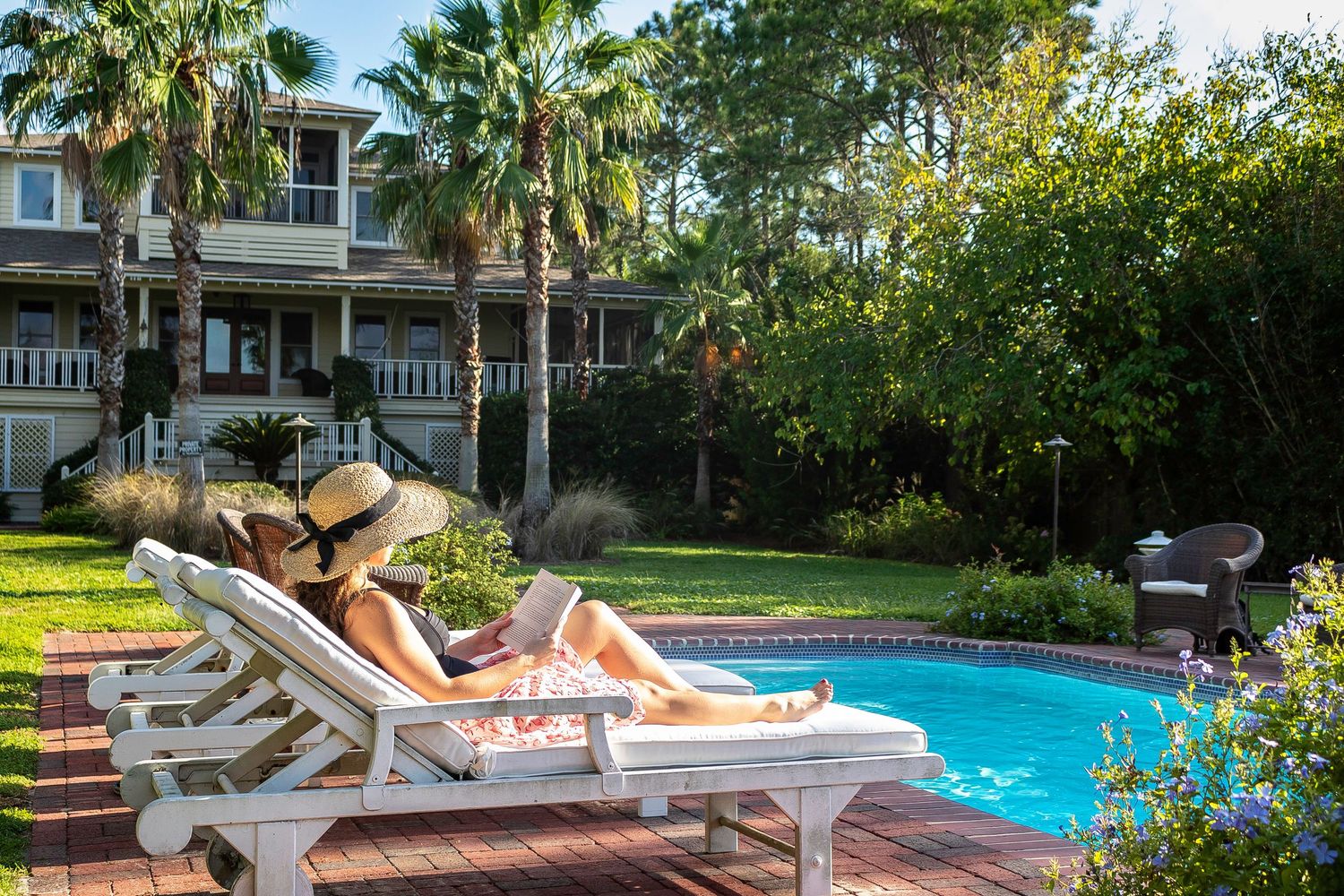 Woman relaxing by the pool at a Tybee Island vacation rental