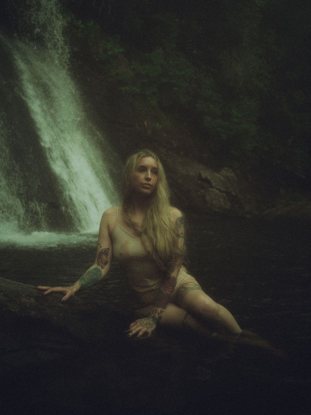 Intimate boudoir portrait beside a waterfall in a natural forest setting in Spartanburg, SC