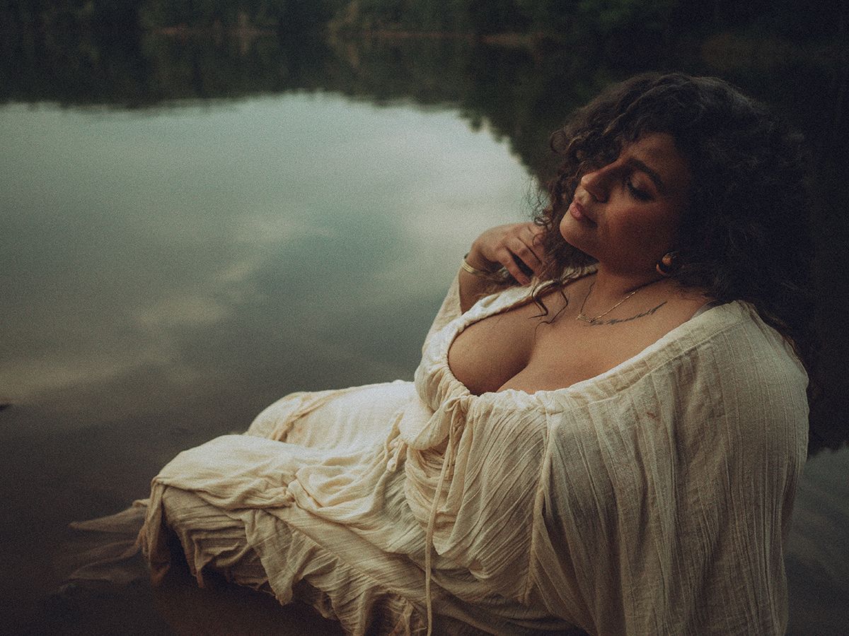 Moody and dreamy branding photograph showing a person in flowing white fabric against moody outdoor backgrounds at dusk in Spartanburg, SC.
