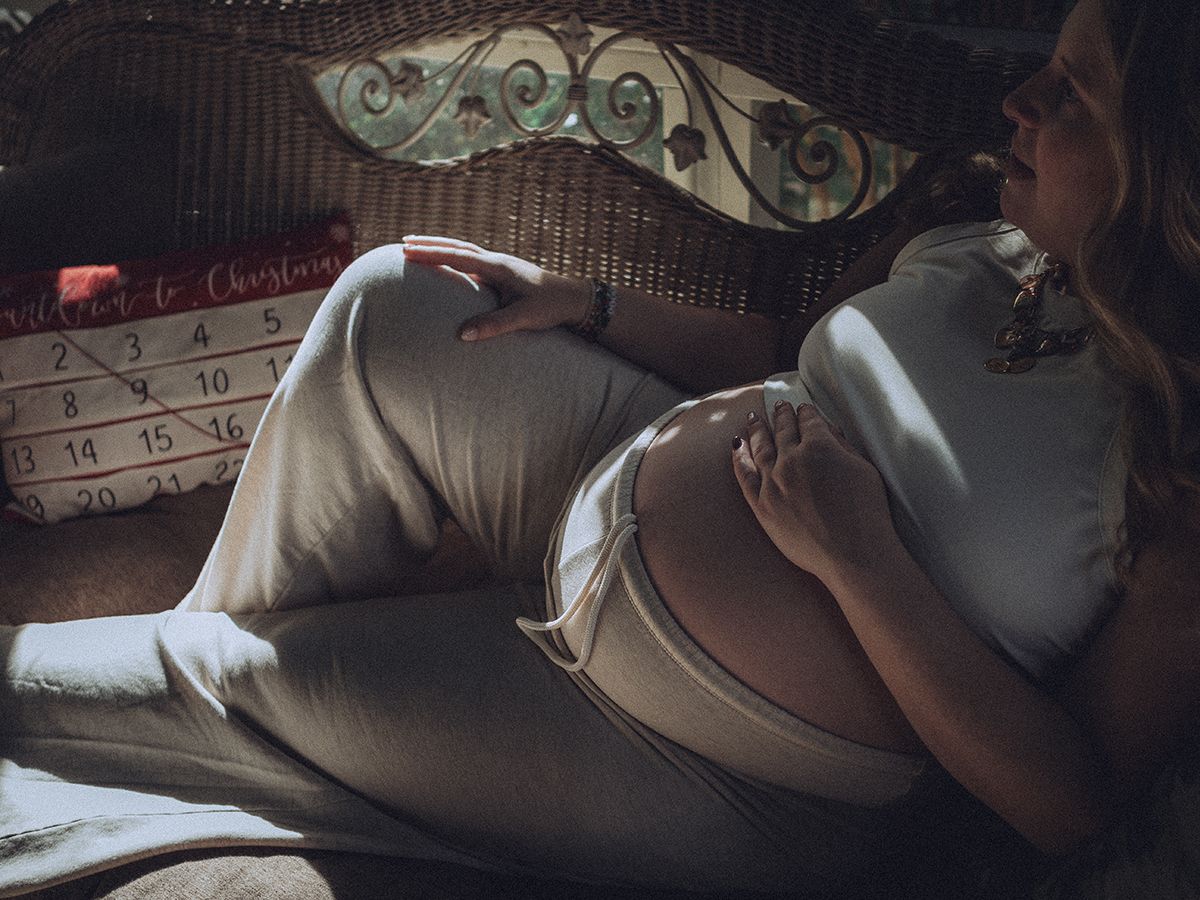 Maternity boudoir photograph in soft light in Spartanburg, South Carolina.