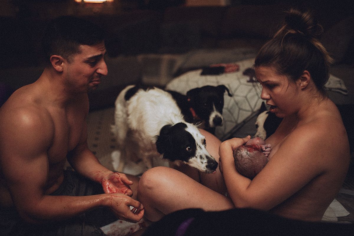 An intimate moment between two new parents after a home birth in Spartanburg, South Carolina.
