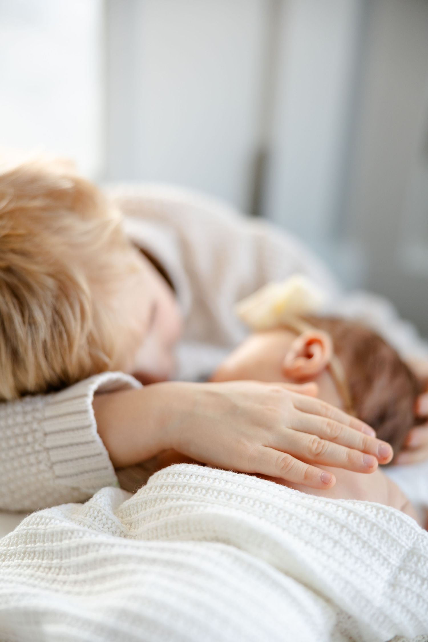 Brother snuggles his newborn sister during in-home newborn session in Hendricks County by Katy Rose Photography.