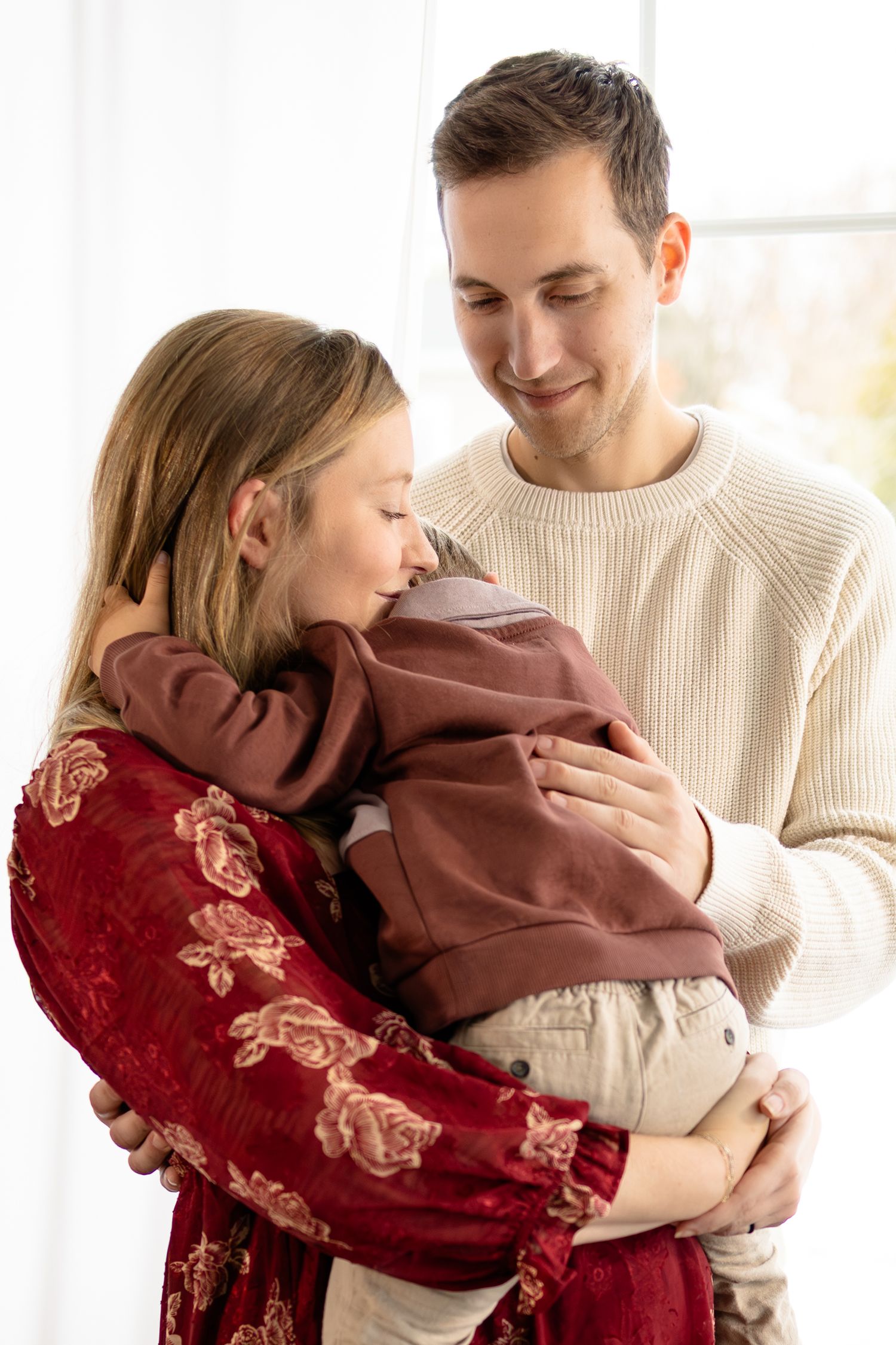 Sweet moments captured between couple and their child during studio maternity session in Brownsburg, Indiana by Katy Rose Photography