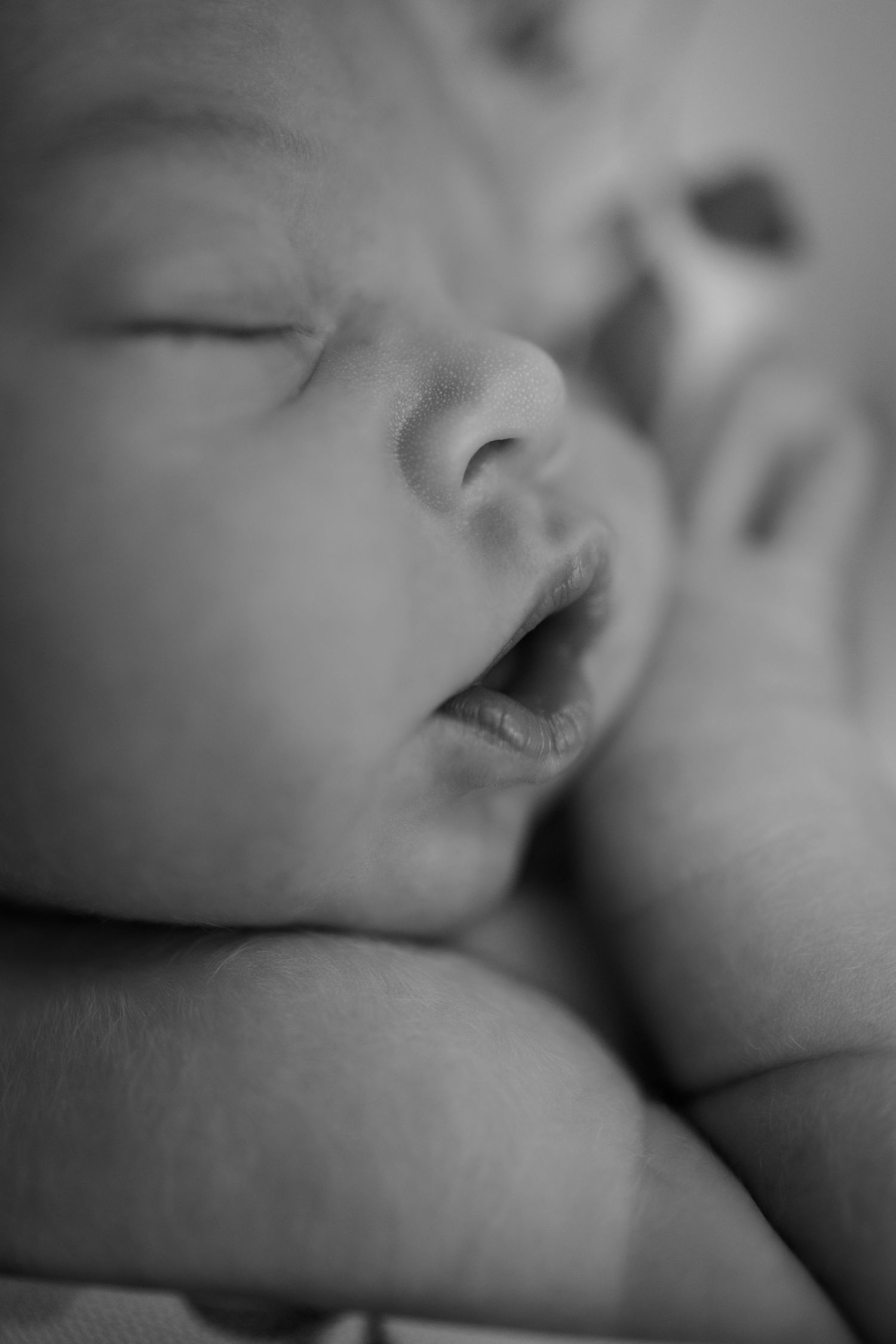 Close-up black and white photo of a sleeping newborn baby during newborn portrait session in Avon, Indiana by Katy Rose Photography