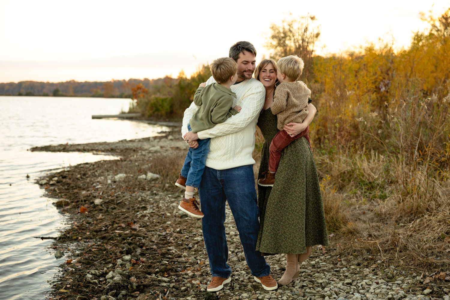 Family spending time together on a rocky shoreline during golden hour at Eagle Creek State Park for Family Portrait Session