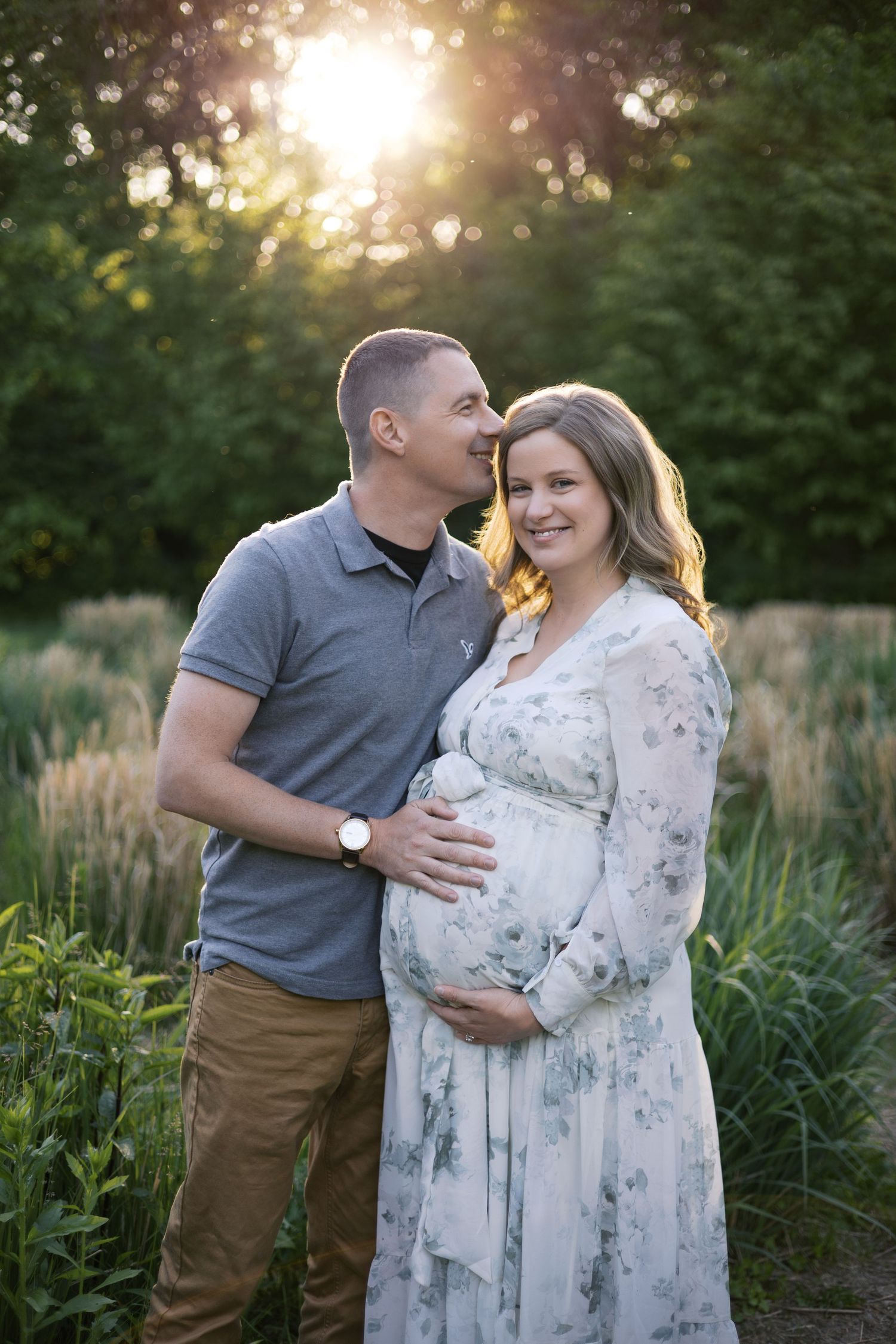 Couple poses outdoors at golden hour for maternity session in Indianapolis by Katy Rose Photography.