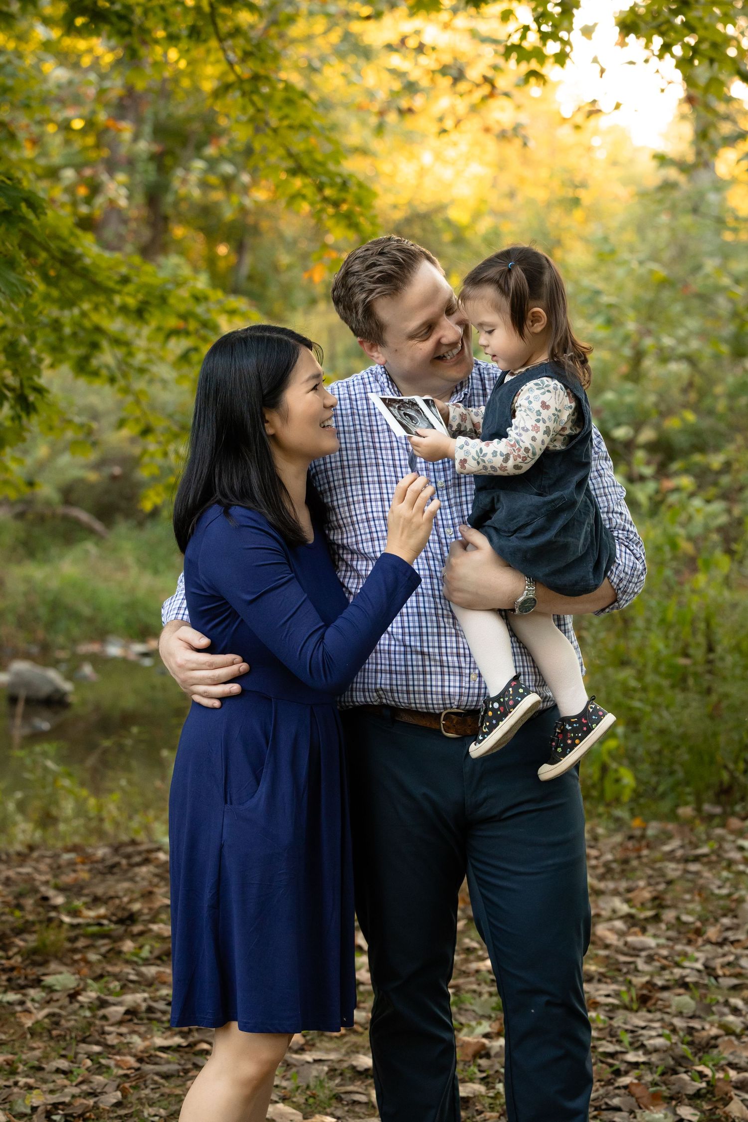 A family of three during their family photos at Arbuckle Park in Brownsburg, Indiana by Katy Rose Photography.