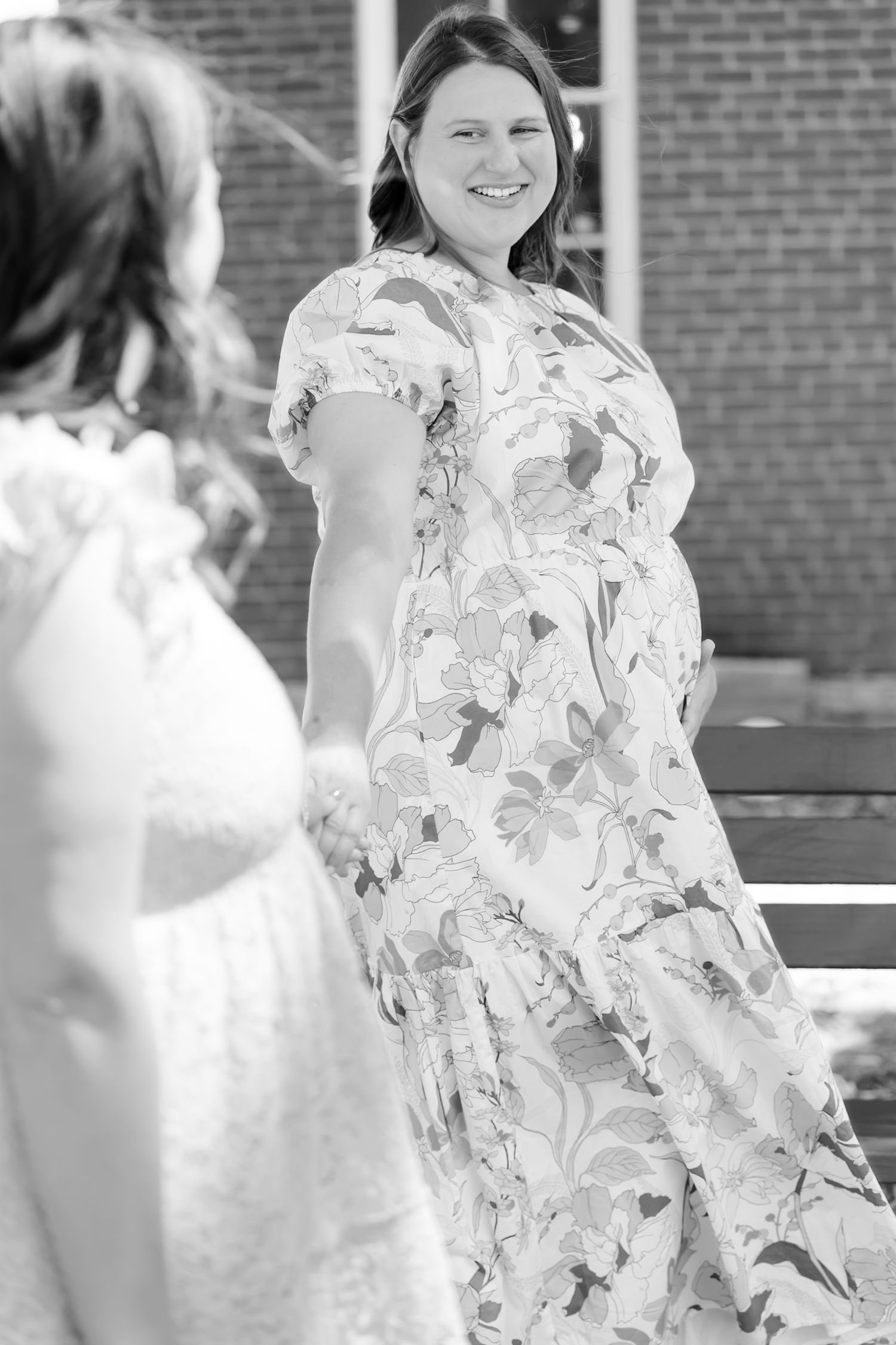 Black and white photos showing movement and fabric details of floral dresses.
