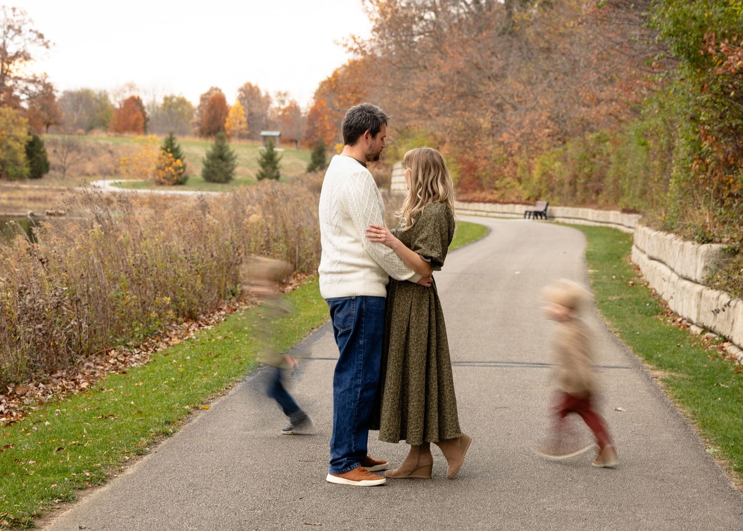 Kids running around parents during family portraits in Hendricks County Indiana.