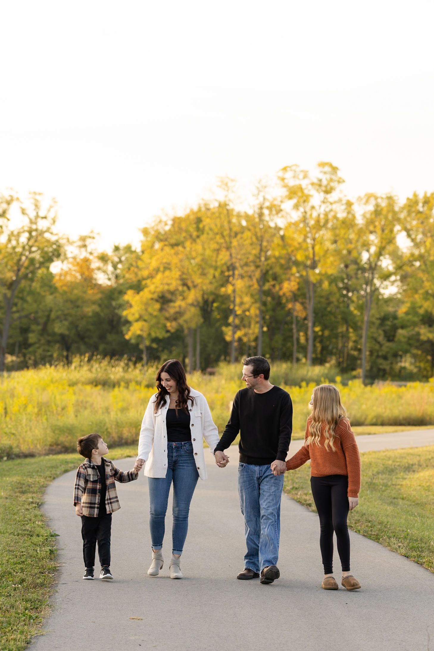 Family walking together at W.S. Gibbs Memorial Park for fall family photography session in Hendricks County Indiana.