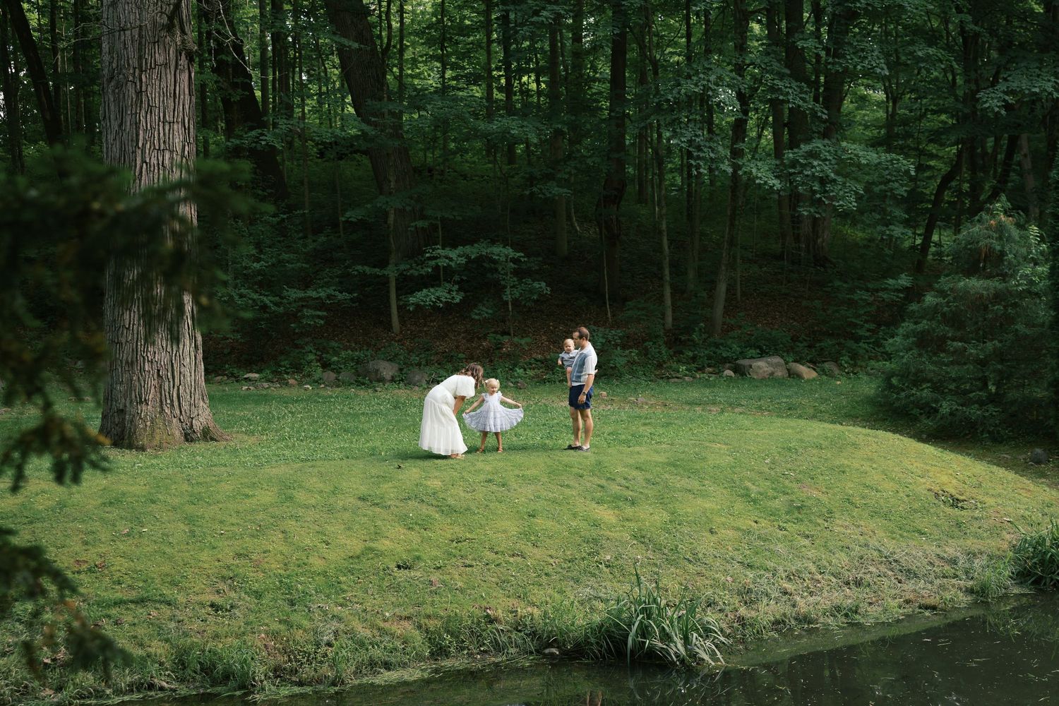 Family of four playing during their Family Photography Session at Holcomb Gardens by Katy Rose Photography.
