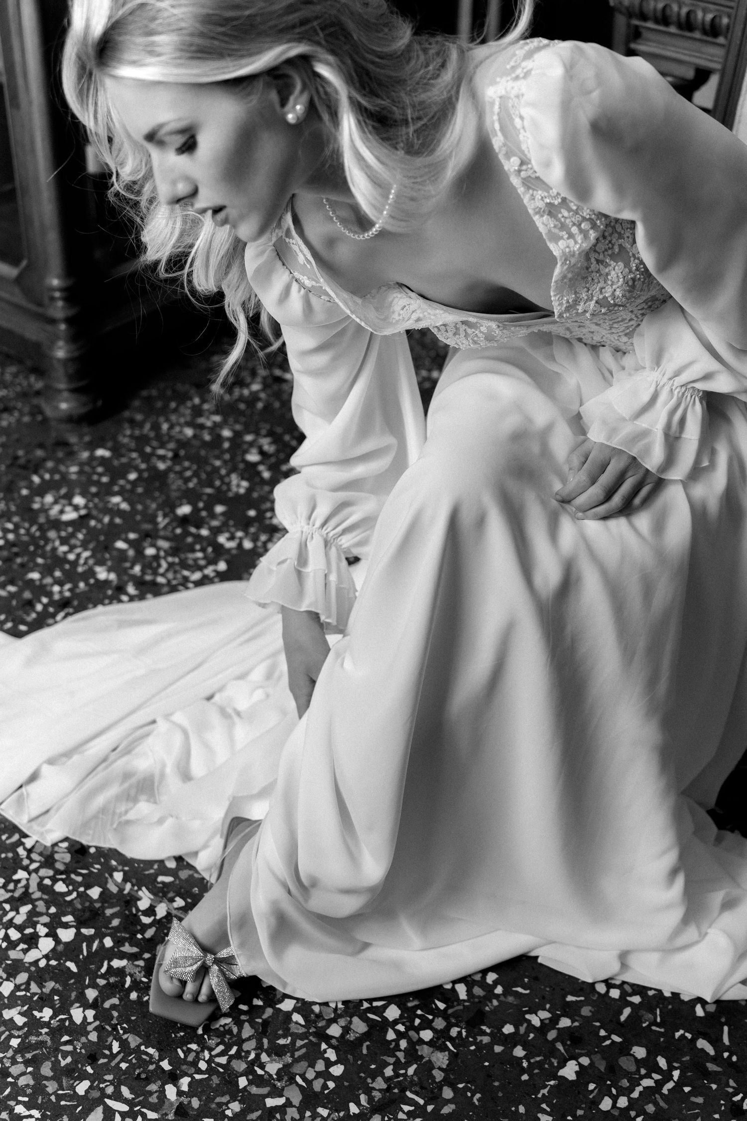 A series of black and white photos showing the flowing fabric of a white dress against a dark background. Wedding Verona