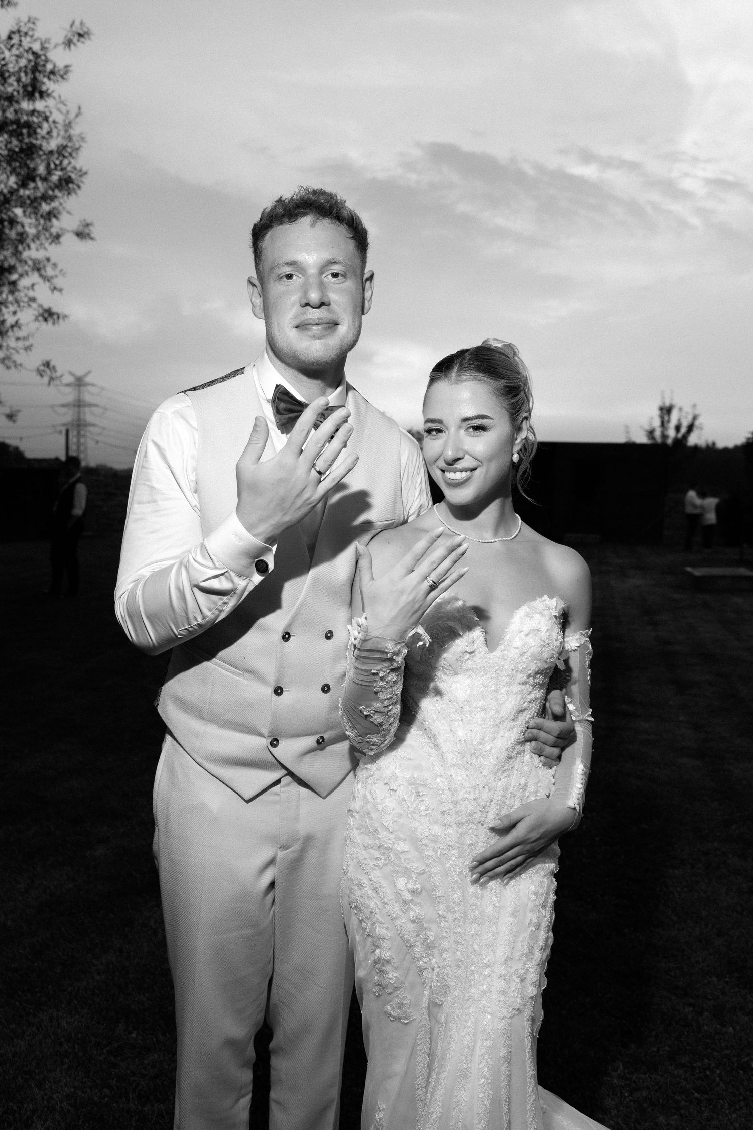 A black and white series of wedding photos showing a couple posing together outdoors at sunset.
