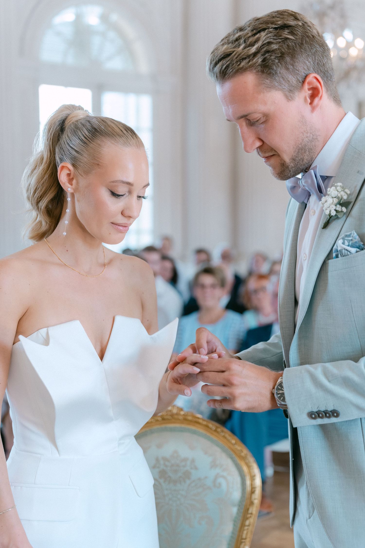 Elegant wedding ceremony sequence showing couple exchanging rings in ornate venue with soft lighting. Schloss Solitude