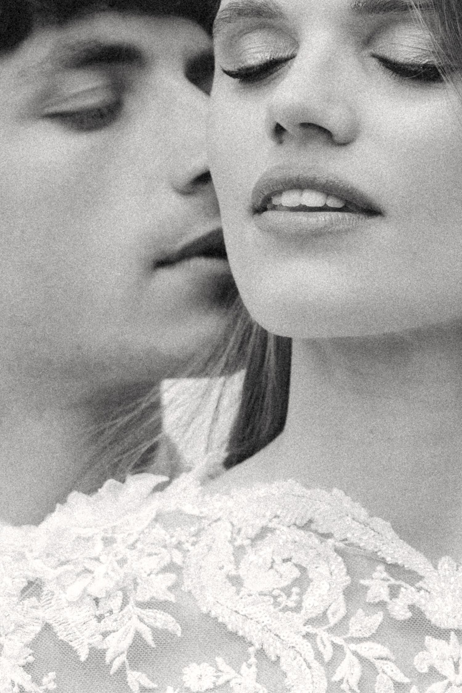 Black and white close-up photo showing tender romantic moment with delicate lace details. Villa Mosconi Bertani