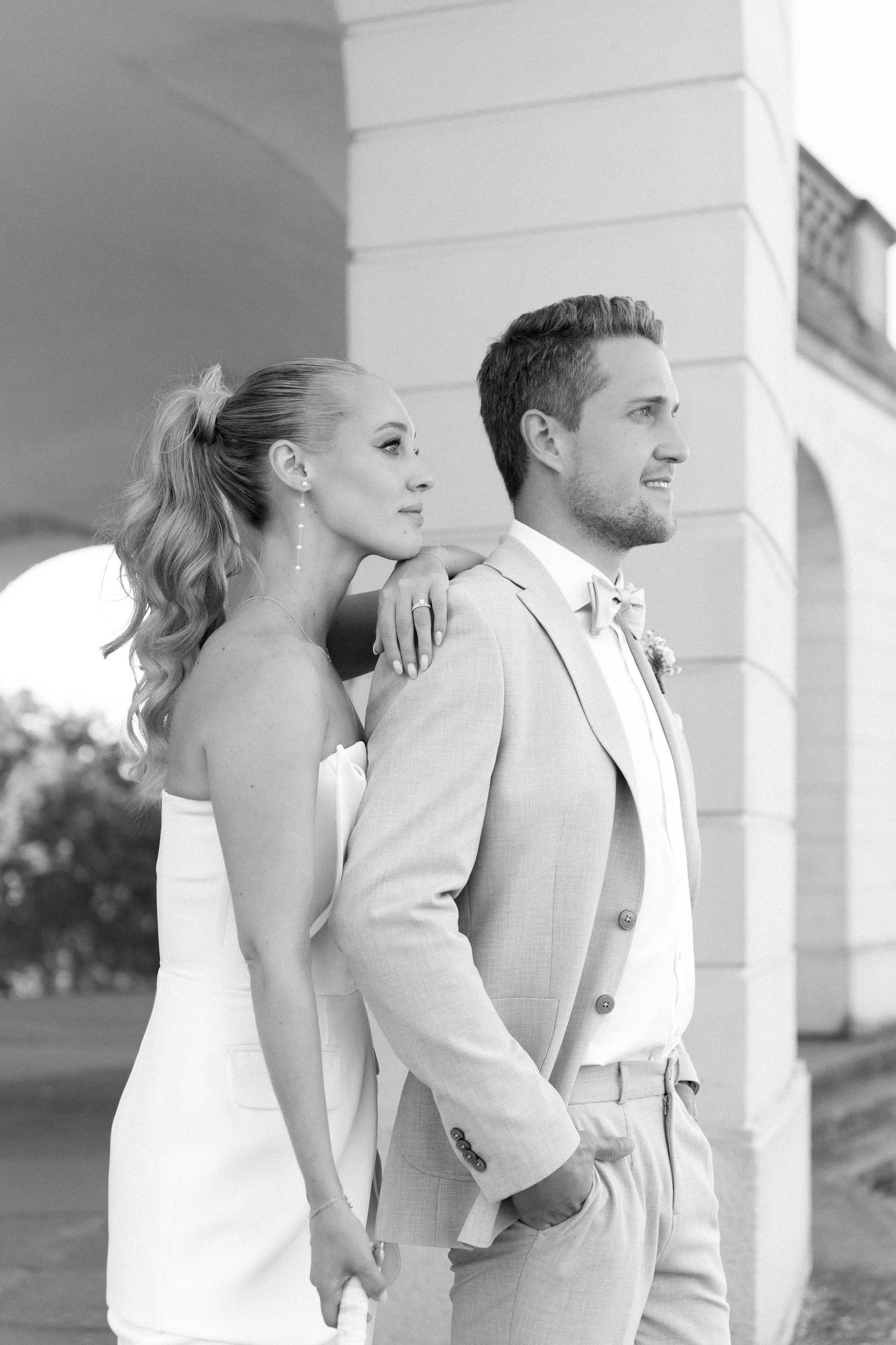 Black and white wedding photos showing couple in elegant poses against white columns in three artistic shots. Schloss Solitude