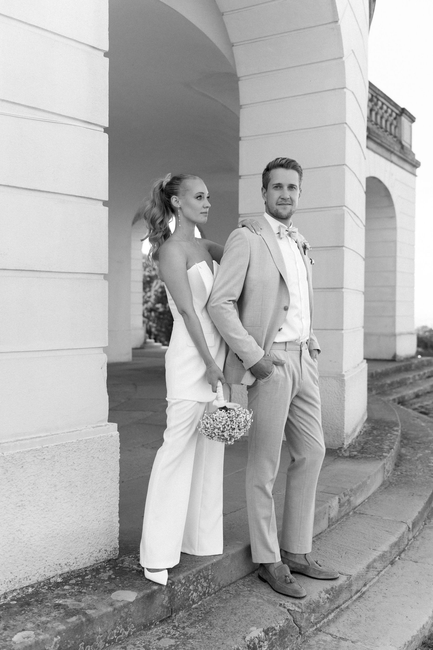 Black and white artistic photo series showing couples standing between white columns in formal attire. Schloss Solitude