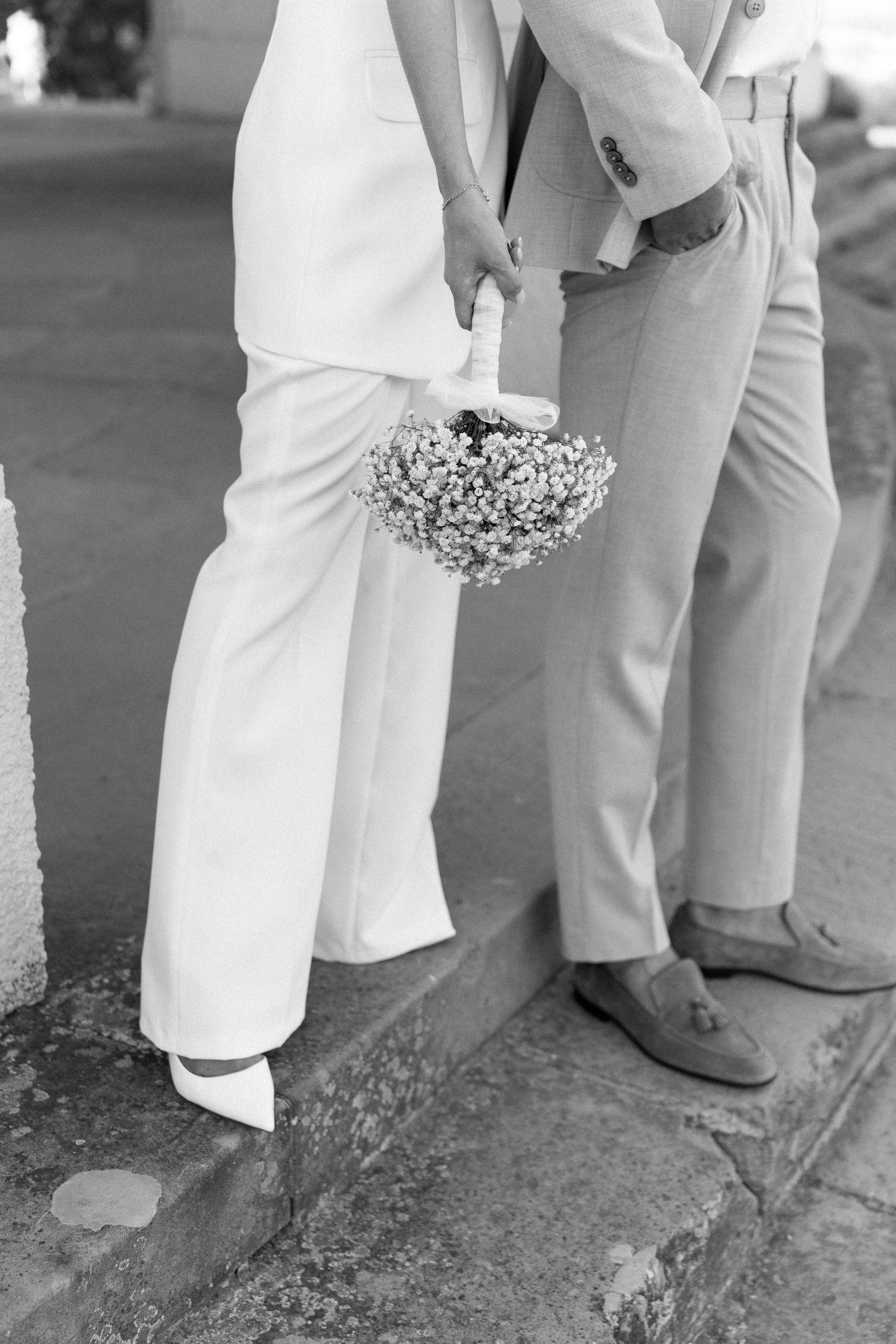 Black and white series of wedding photos showing dress details and shoes of wedding party members standing together. Schloss Solitude