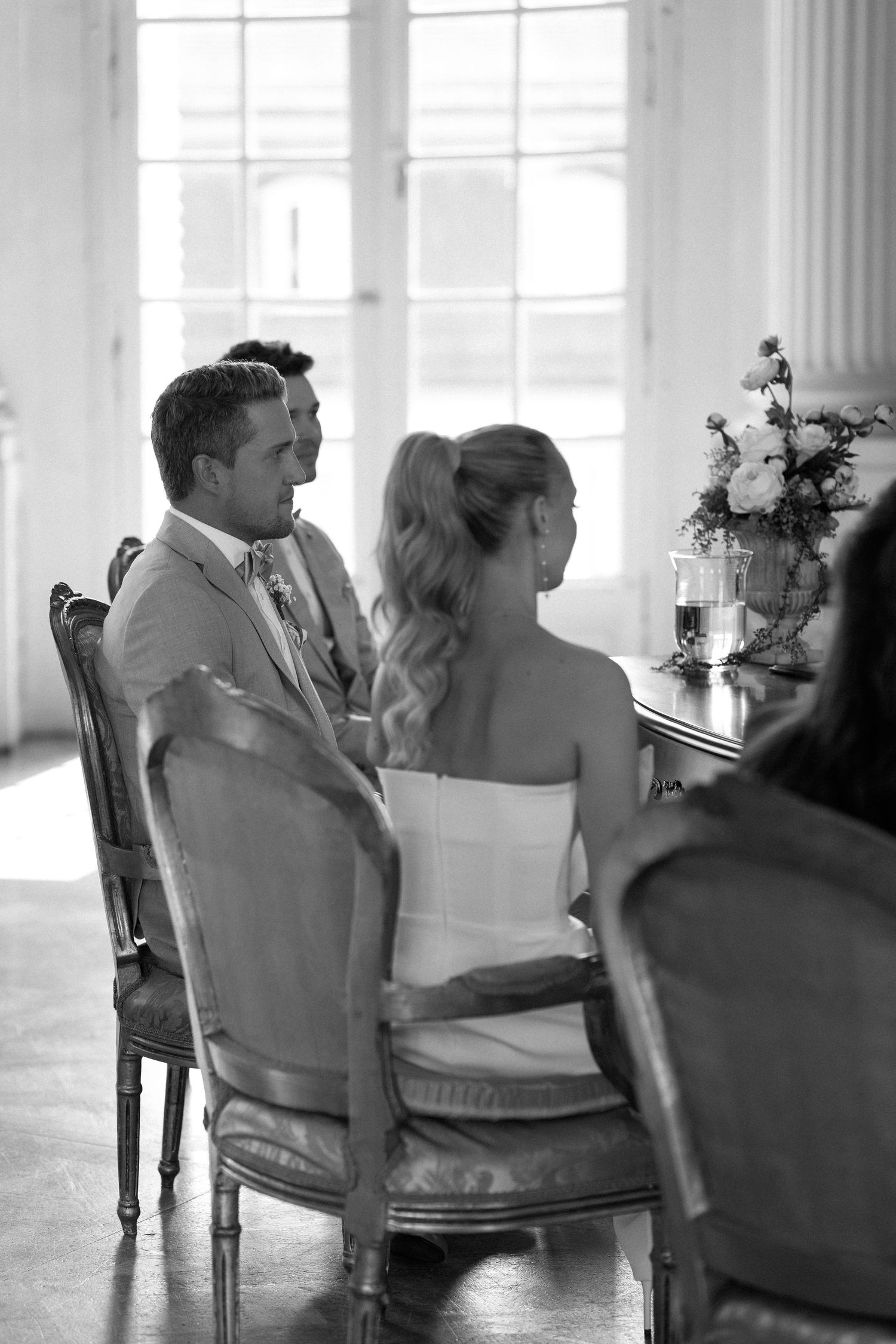 A romantic black and white photo series showing a couple sitting together in elegant vintage chairs. Schloss Solitude