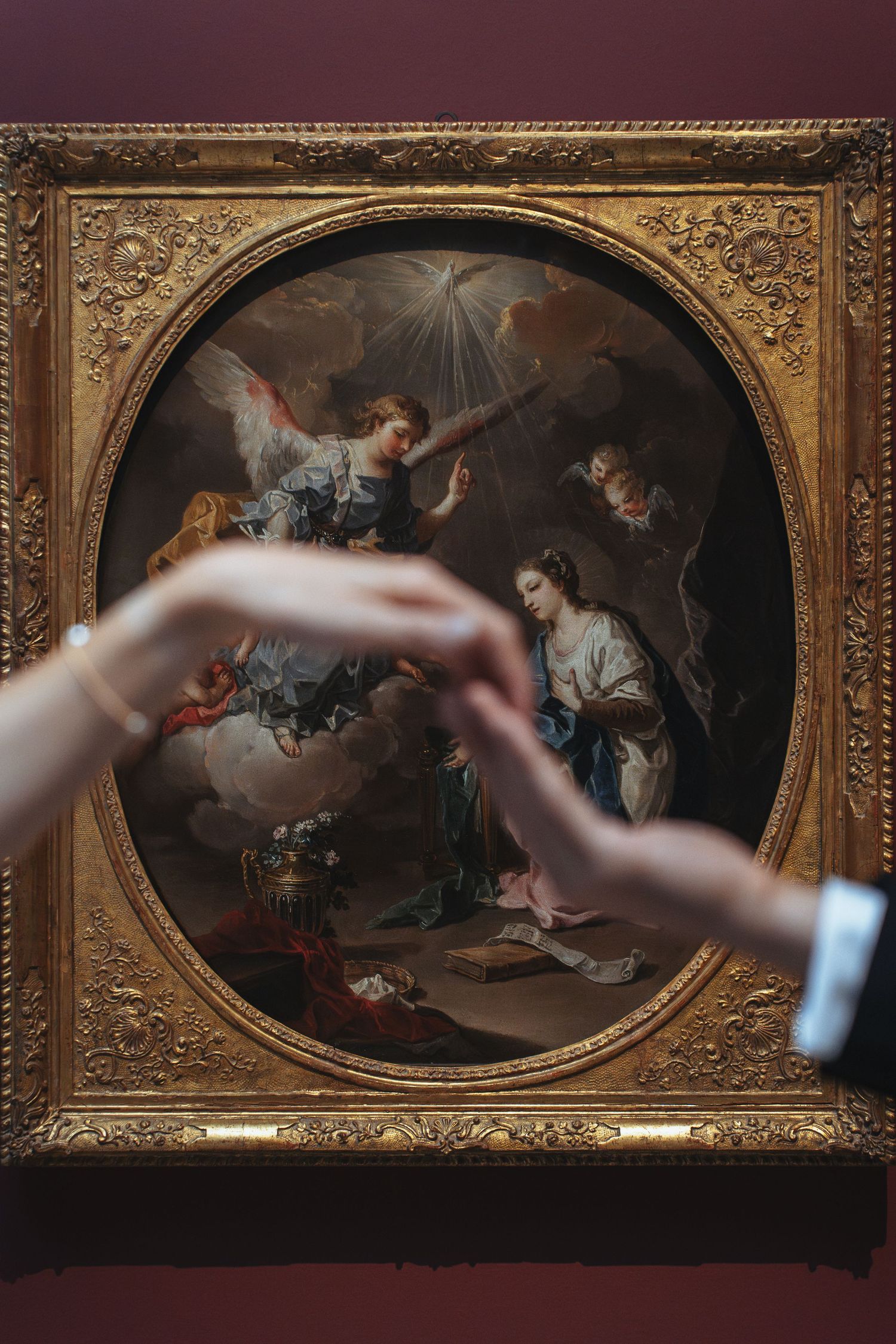 Ornate gold-framed classical paintings displayed in sequence on a museum wall with dramatic lighting.
