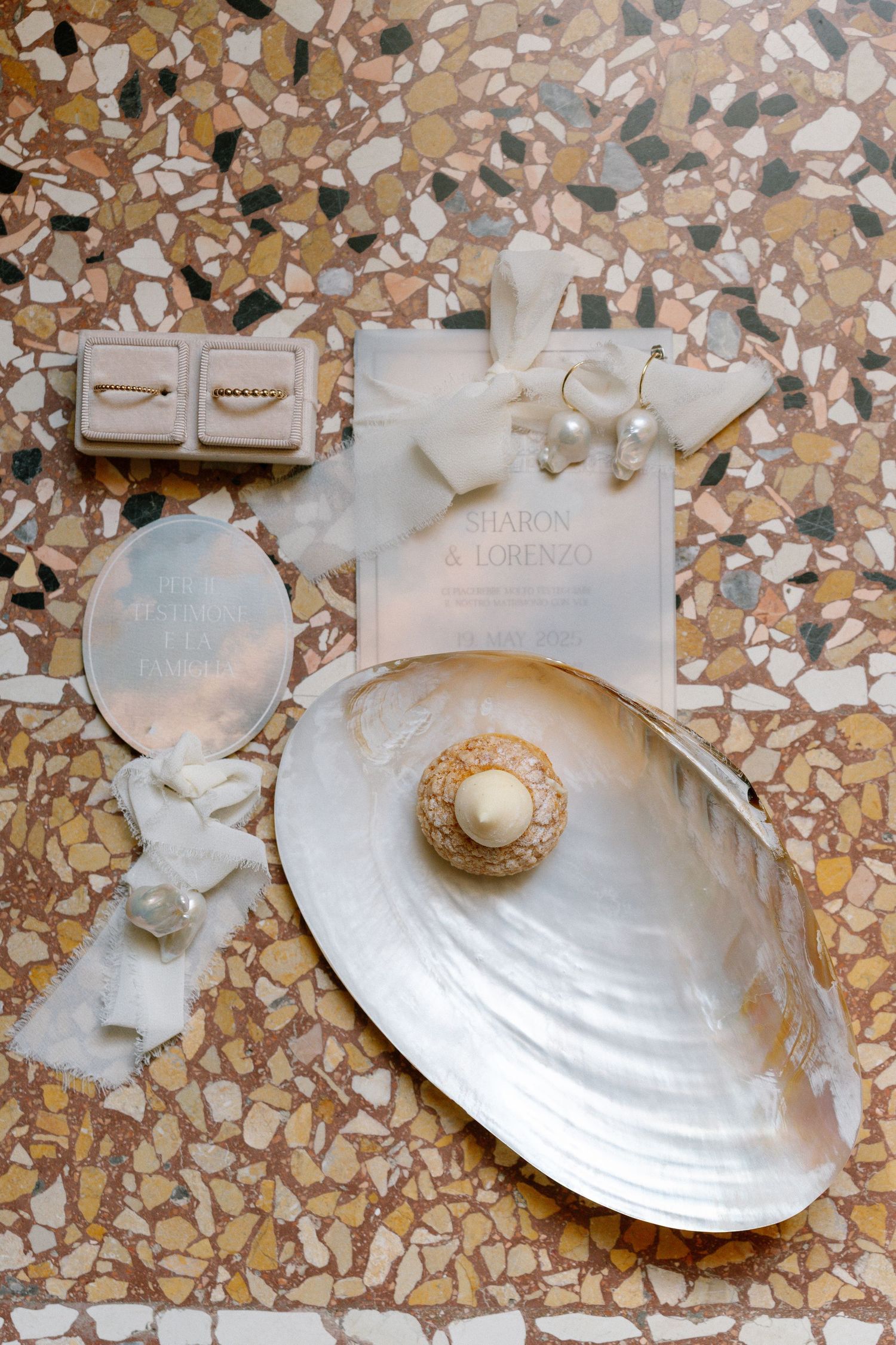 A series of six photos showing a white seashell on a textured stone or tile surface. Villa Mosconi Bertani