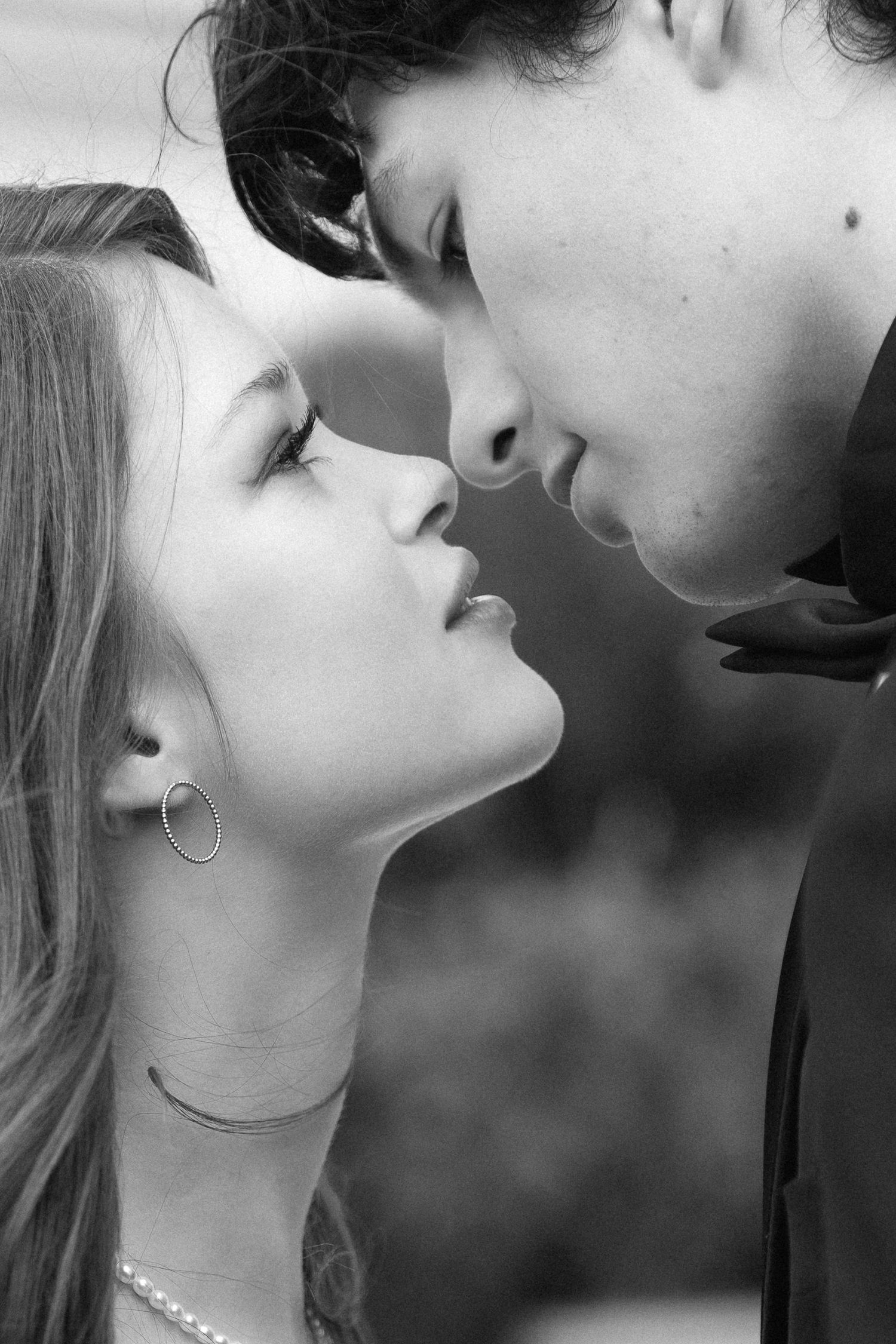 A series of black and white romantic close-up profile shots showing an intimate moment between two people about to kiss.