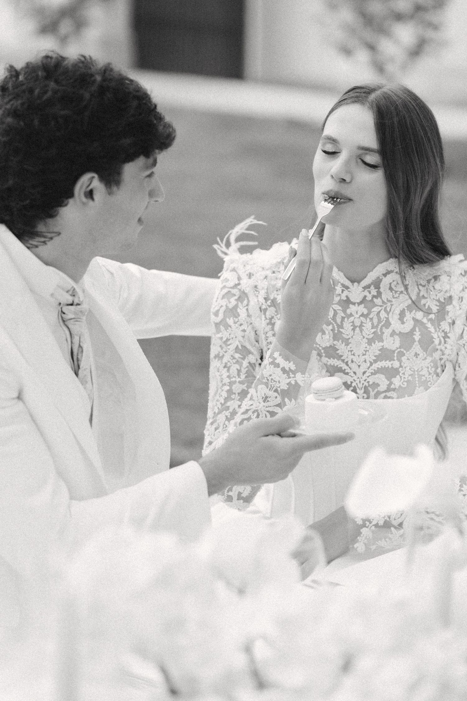 A romantic wedding couple in white attire share intimate moments in a series of black and white photographs. Villa Mosconi Bertani